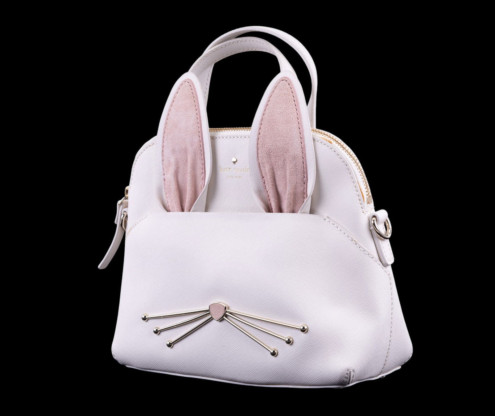 Kate Spade Handbag with Bunny Ears and Strap: Kate Spade handbag featuring a unique bunny ear and whisker design. Made from high-quality materials with a detailed front design, soft-touch ears, and an adjustable strap. Ideal for carrying essentia