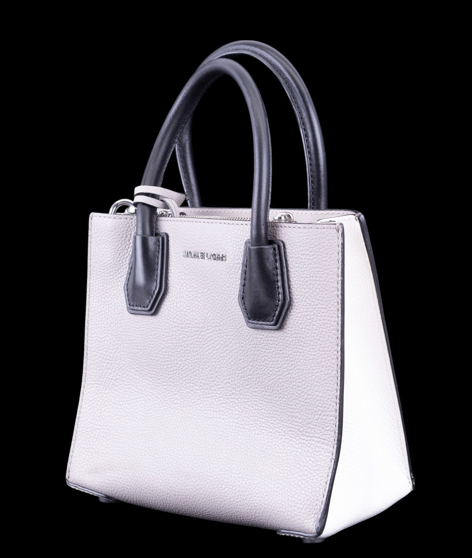 Michael Kors Leather Handbag, Like New Condition: Michael Kors handbag crafted from high-quality leather. Features a sophisticated two-tone design with top-handle straps, silver-tone hardware, and a brand logo on the front. The item is in like-new co