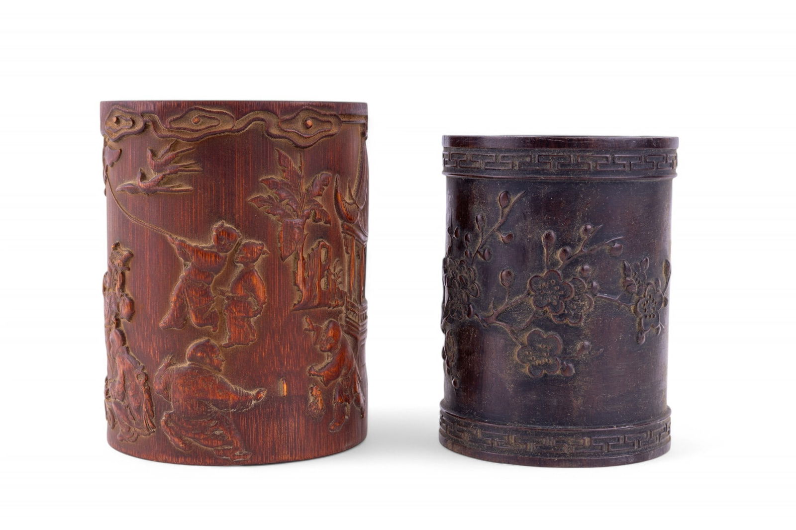 Carved Relief Brush Pots (2): Carved relief bamboo brush pot depicting a village scene, 6.5", and a thick wood carved relief brush pot depicting a cherry blossom motif, 6".