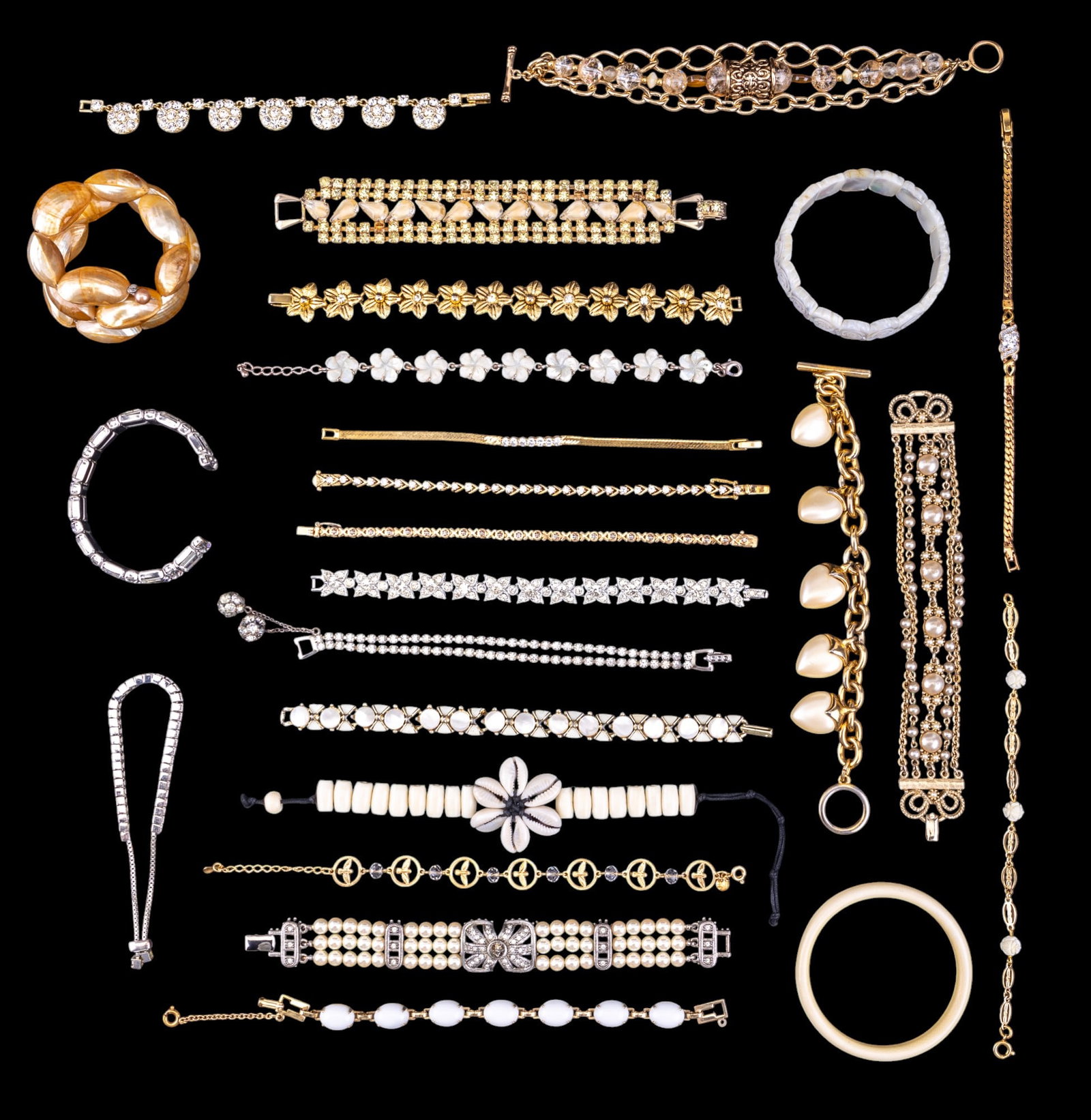 M.O.P., Pearlescent, & Rhinestone Bracelets (25): Collection of 25 bracelets including a bracelet w/ a cowrie shell flower, mother-of-pearl bracelets, pearlescent bracelets, clear rhinestone bracelets, a Barse Thailand chain & bead bracelet, a bone /