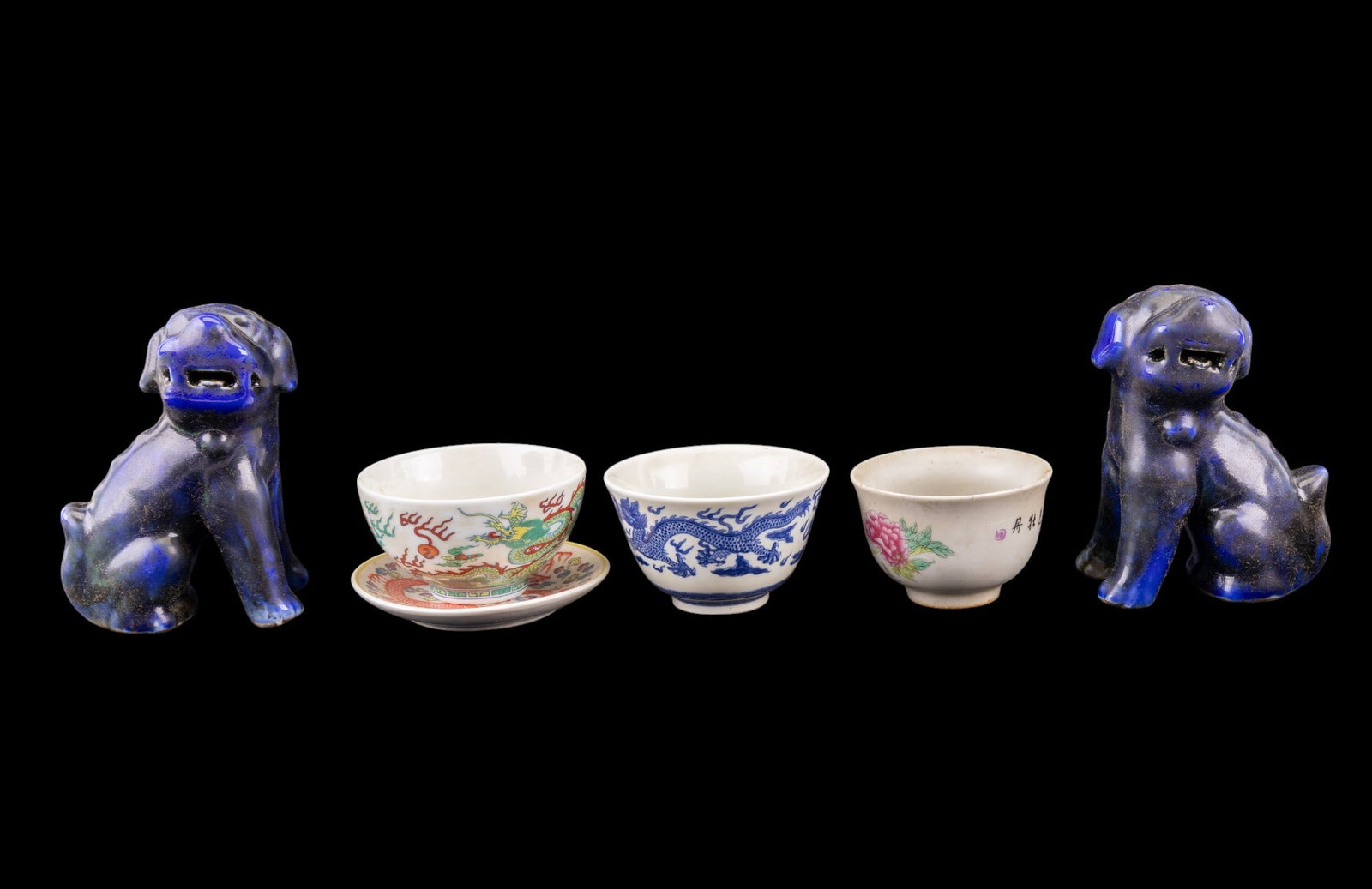 Blue Foo Dog Pair, 3 Teacups & Saucer w/ Marks: Chinese porcelain including a pair of deep blue foo dog figurines approx. 5" tall; a saucer approx. 4" in diameter w/ a 5-clawed red dragon design & the double blue ring regular kaishu script seal mar