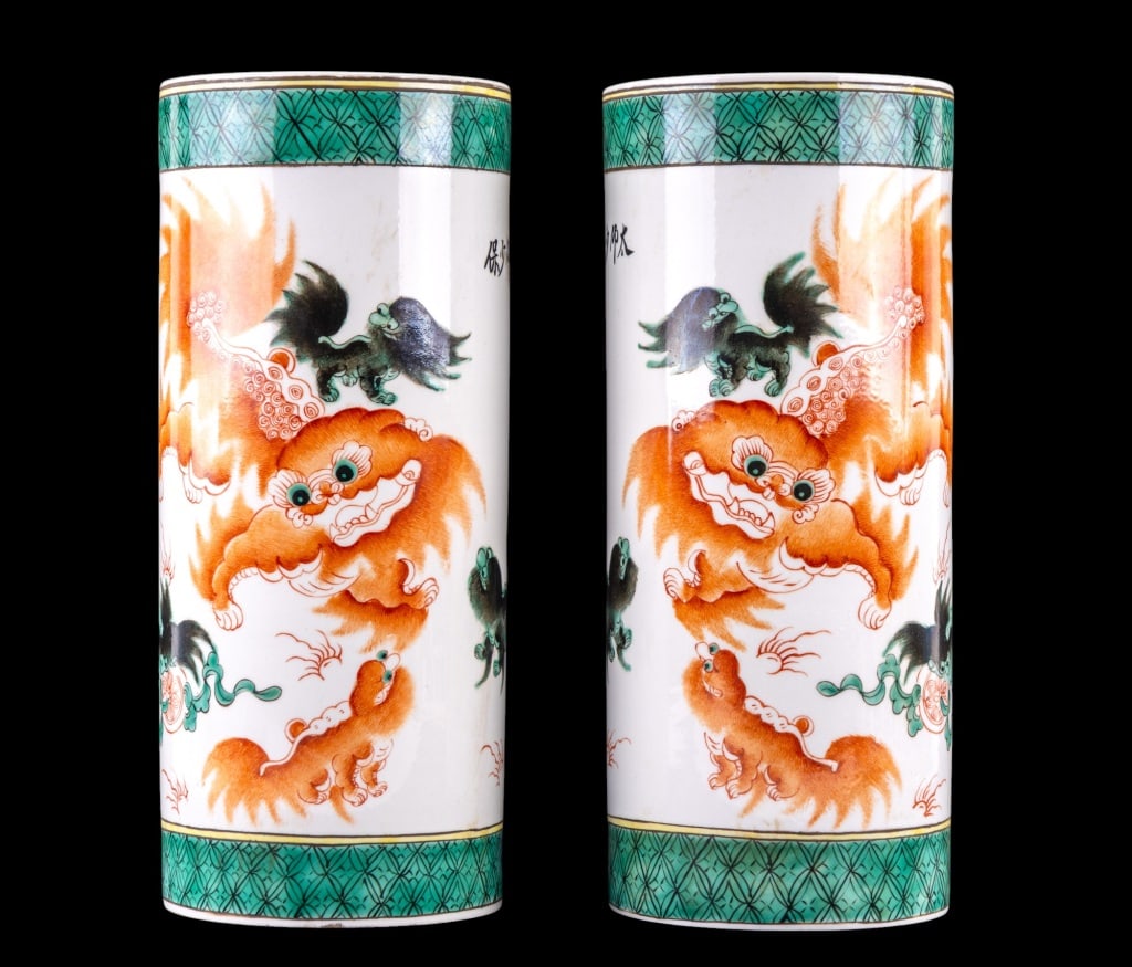Chinese Red Foo Dog Hat Stands w/ Guangxu Mark: Pair of Chinese porcelain hat stands w/ an orange-red adult foo dog / foo lion & cub surrounded by 3 small black & green lion creatures. The designs on the hat stands mirror each other. They also have