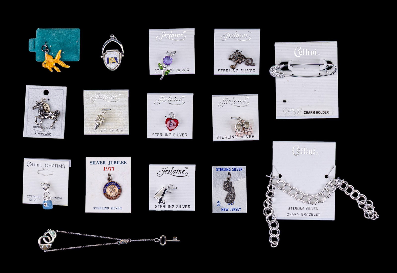 Sterling Silver Charms and Bracelet: Ac collection of 12 sterling silver charms, 7 by Jezlaine, New Jersey souvenir charm, Silver Jubilee Queen Elizabeth charm, a horse by Wheeler, Pennsylvania Farm Show charm, an enamel gold fish, a han