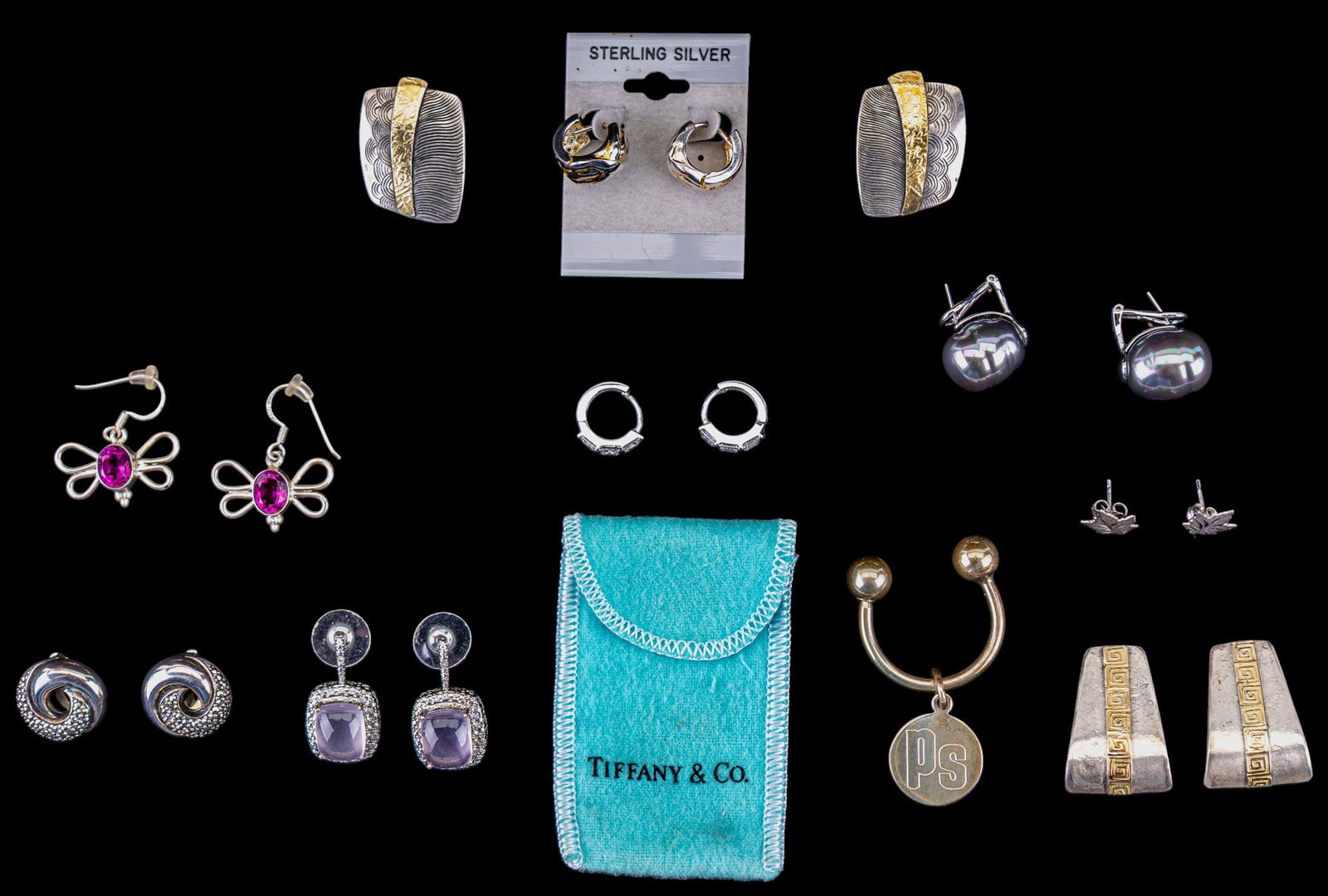 Tiffany & Co Key Chain and Sterling Earrings: A collection of sterling silver stud, drop, and clip on earrings featuring butterflies with pink stones, incised maple leaf studs, large grey freshwater pearl pierced earrings, a Tiffany & Co horsesho