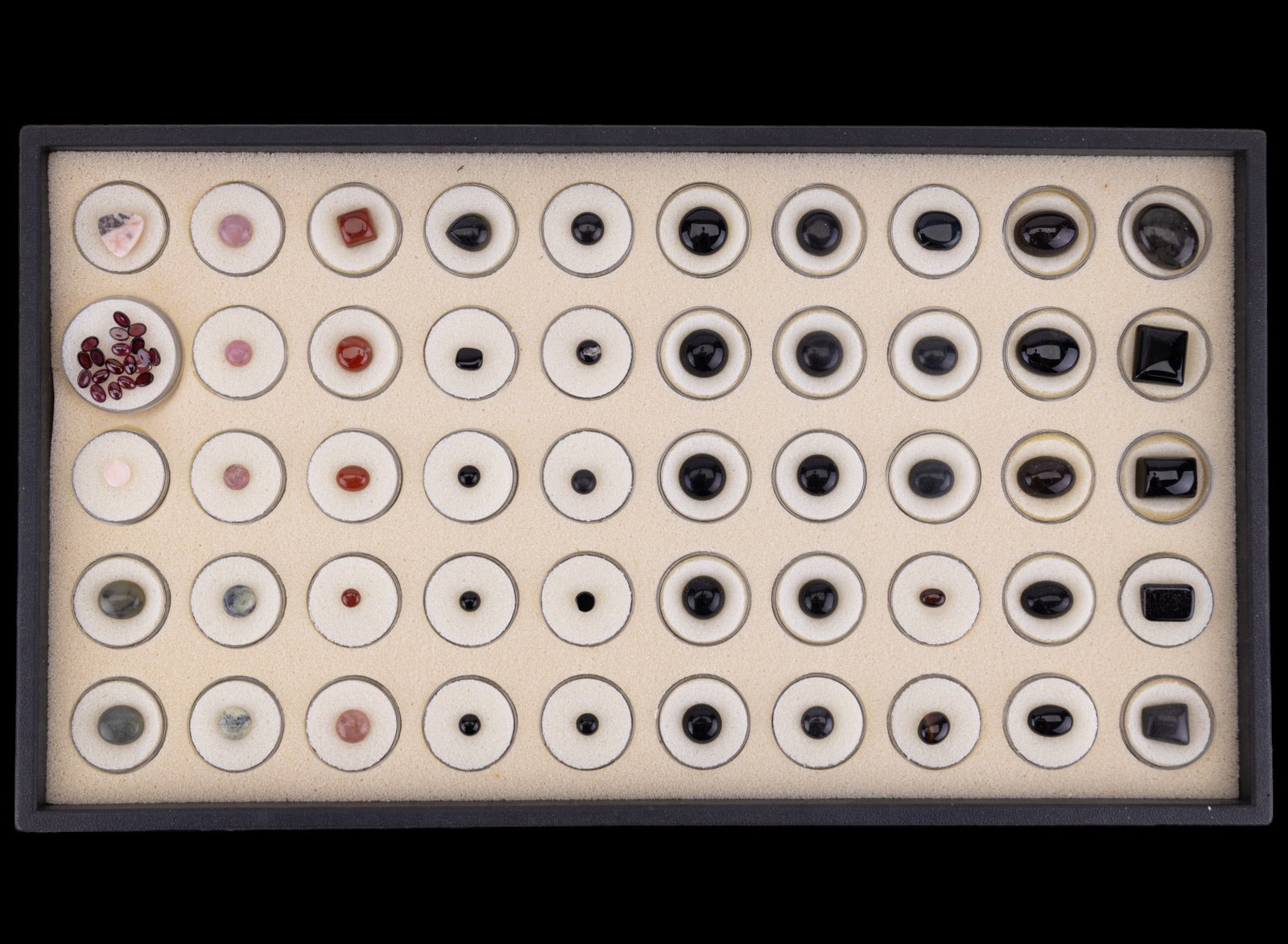 Grouping of 50 Semi-Precious/Natural Stones: A grouping of colorful and semi precious stones including a container of stones testing for garnet, and many other polished stones. Many thought to be smoky quartz; red stones test for hardness of aga