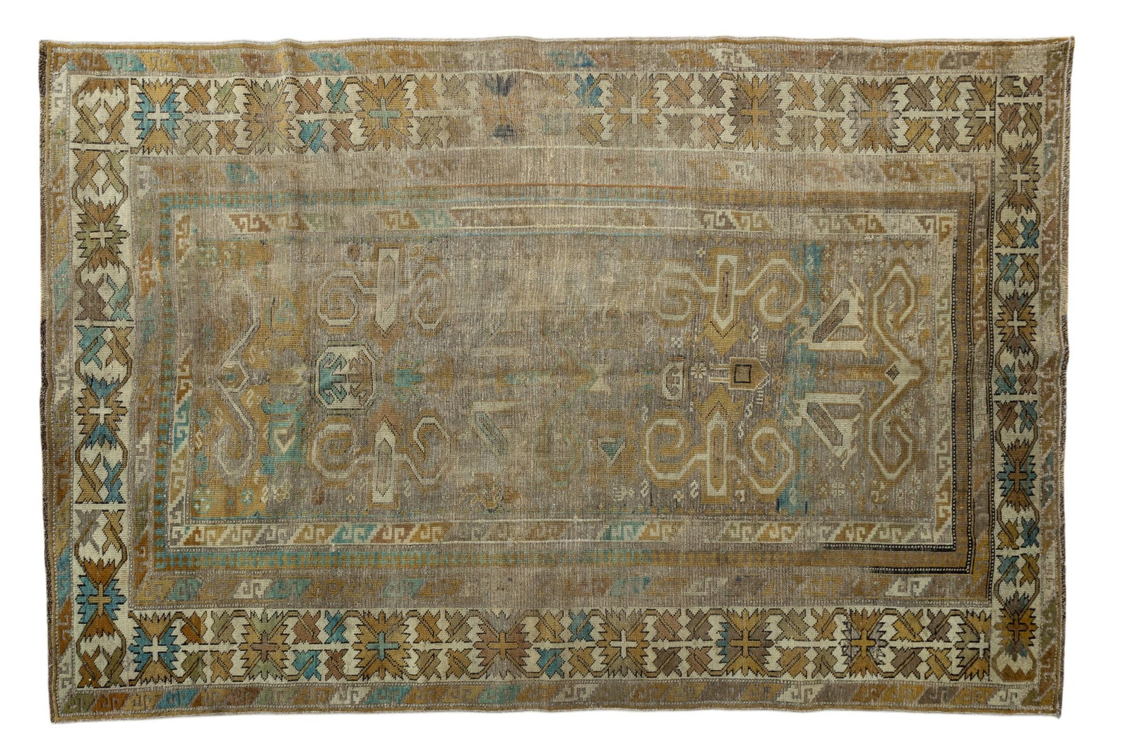 Turkish Ghiordes Rug: Turkish Ghiordes rug or similar Caucasian rug approx. 6' x 4' w/ tan, brown, ivory, & blue-grey patterns w/ geometric motifs. Rug appears to be antique. There is visible pile loss. See photos for furt