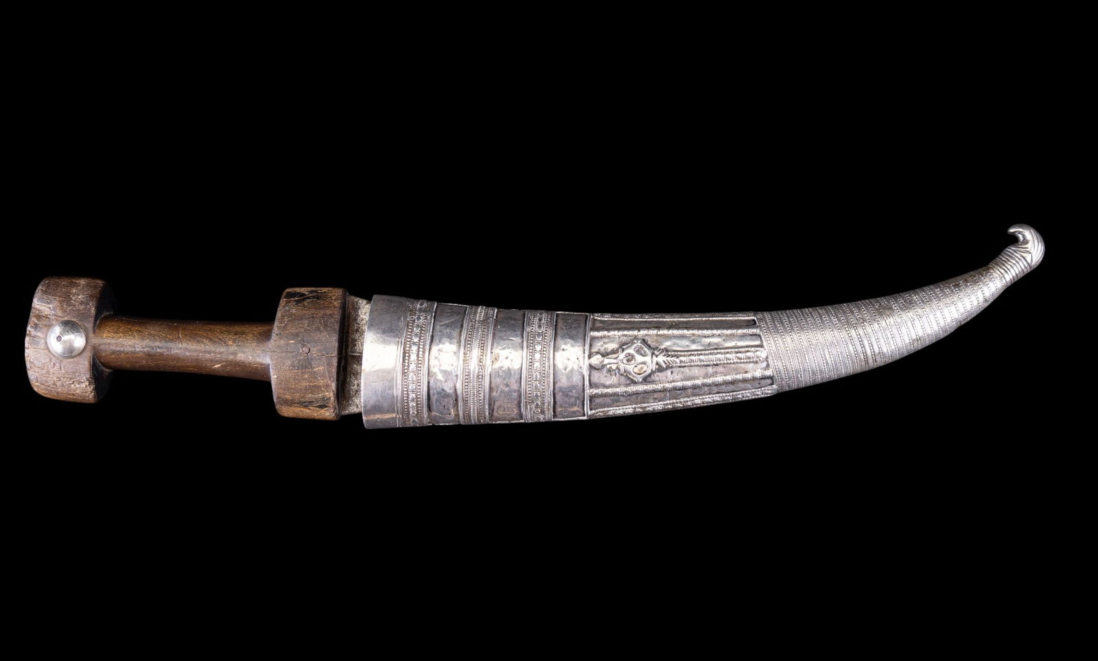 Jambiya Fine Silver Dagger w/ Horn Handle: Jambiya fine silver dagger w/ horn handle & intricately-detailed sheath. Jambiya daggers originated from the Hadhramaut region in Yemen. They have spread to other countries in the Middle East, to othe