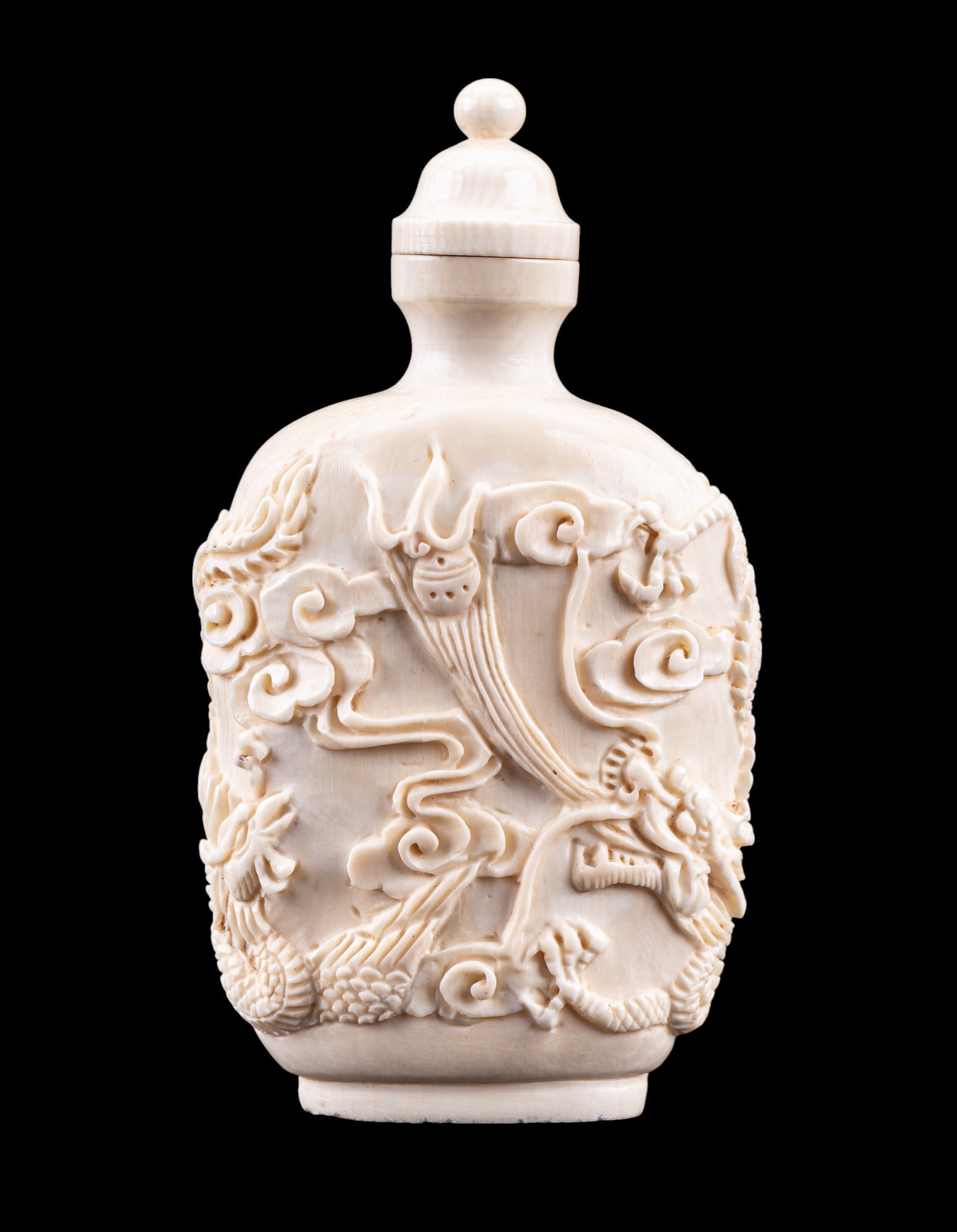 Chinese Carved Bone Dragon & Phoenix Snuff Bottle: Chinese carved bone / natural material snuff bottle w/ design of a 5-clawed dragon & a fenghuang phoenix fighting over the Wish-granting Pearl / flaming pearl, one of the Eight Treasures. Item measure