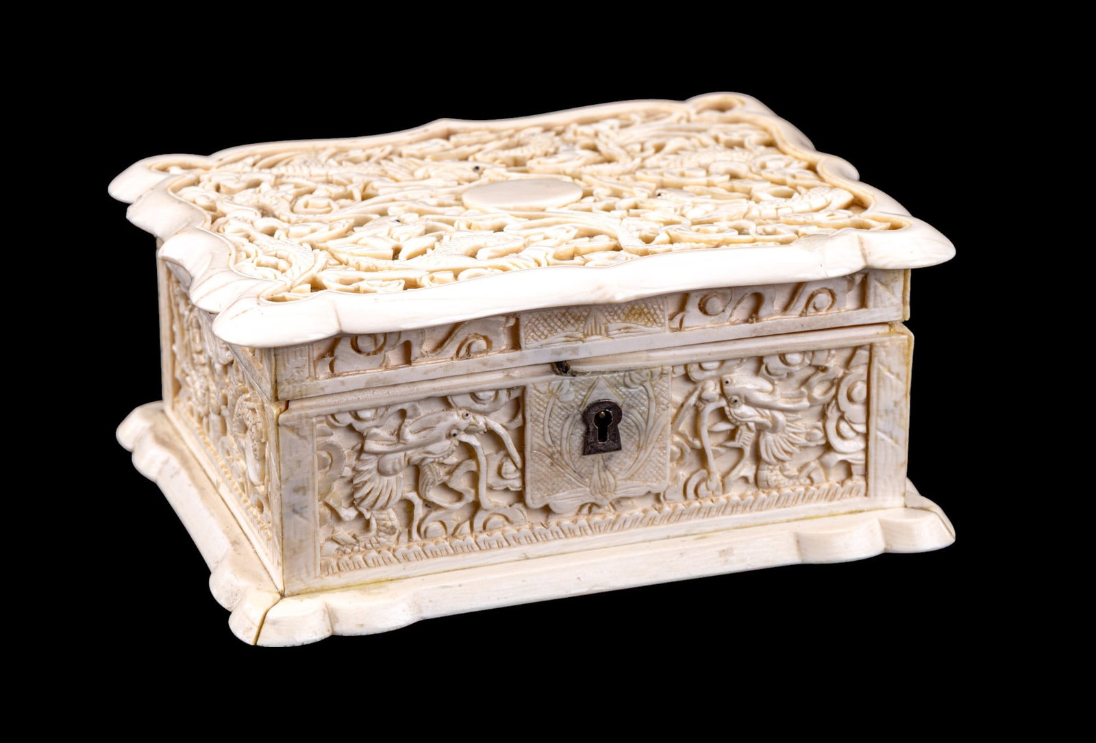 Chinese Carved Bone Trinket Box w/ Dragons: Chinese carved bone / natural material trinket box w/ design of dragons & clouds on each side. Key is not included. Item measures approx. 4" long x 5.25" wide x 2.25" tall. Item must be sold to a Penn