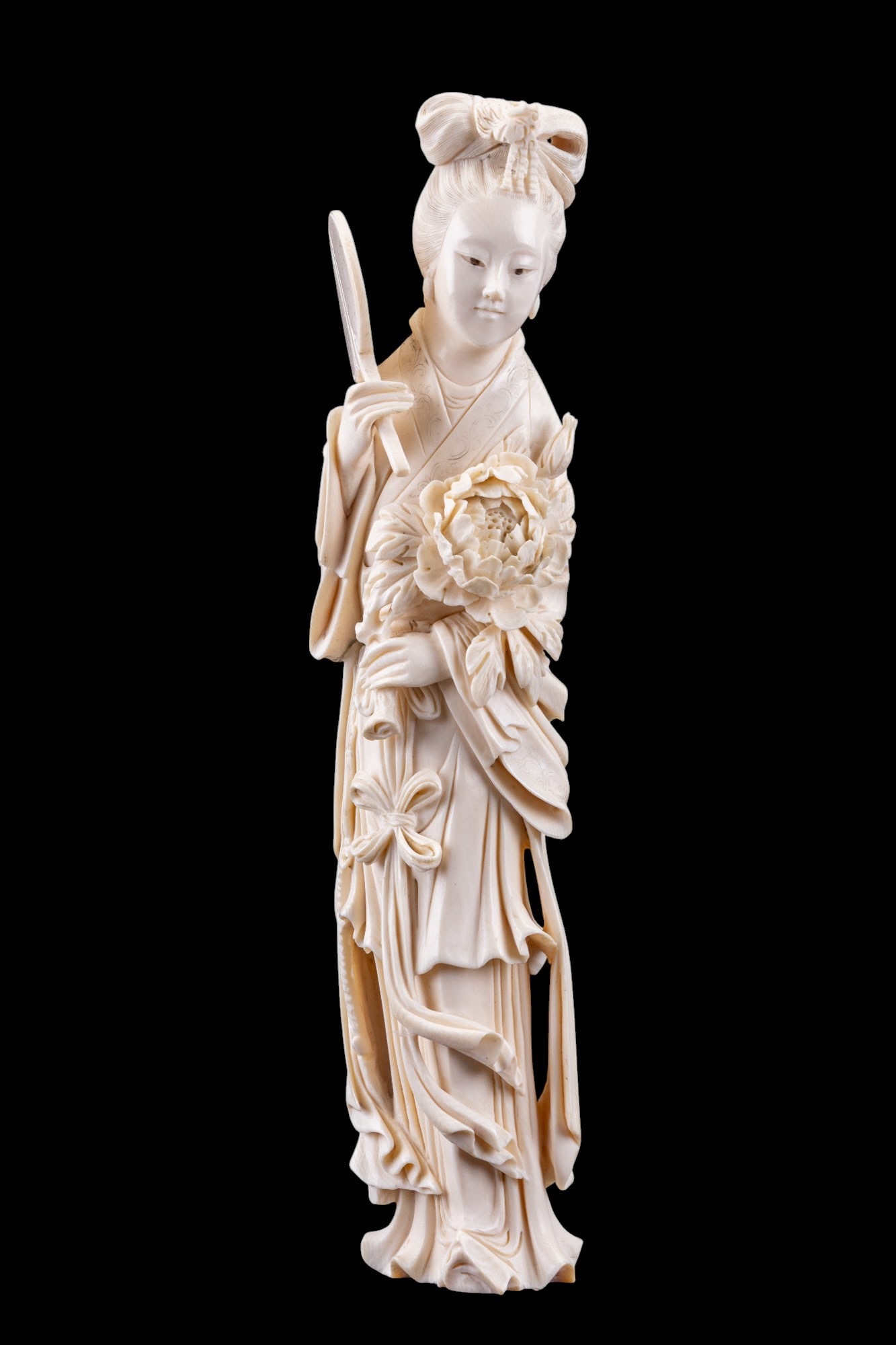 Chinese Carved Bone Princess Figurine: Highly-detailed Chinese carved bone / natural material figurine of a princess or woman of higher status. She is holding a bouquet of flowers in her left hand & a fan in her right hand. Figurine measur