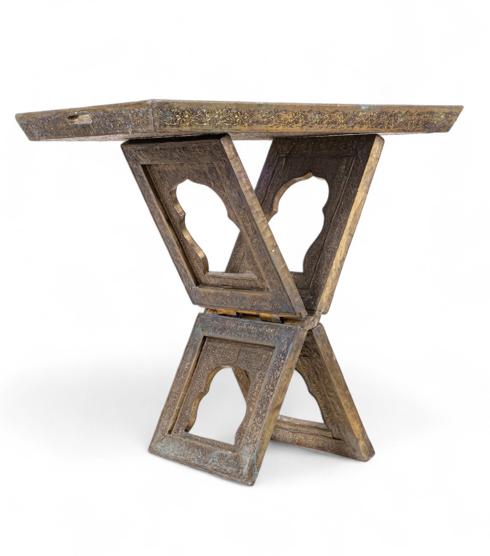 South Asian Copper-Covered Wood Folding Tray Table: South Asian copper-covered wood folding tray table w/ floral design & arched, keyhole-shaped openings in the folding base that are consistent w/ Tibetan or South Asian motifs. Tray measures approx. 30