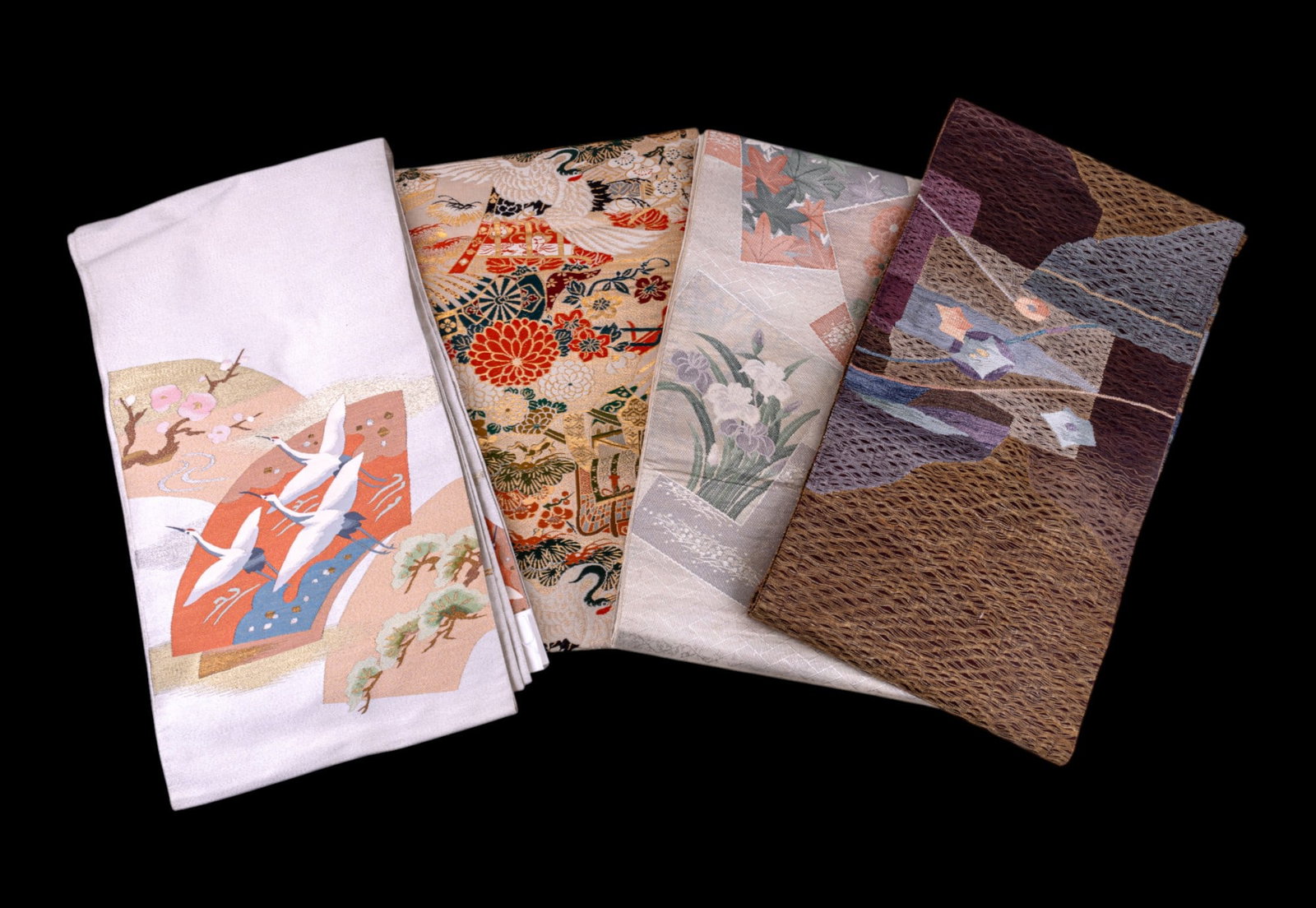 Japanese Obi (Sash) Belts w/ 4 Unique Designs: Collection of 4 Japanese obi belts of unique designs including one w/ red-crowned cranes in an elaborate botanical scene w/ gilded detailing, another w/ red-crowned cranes flying over a landscape w/ g