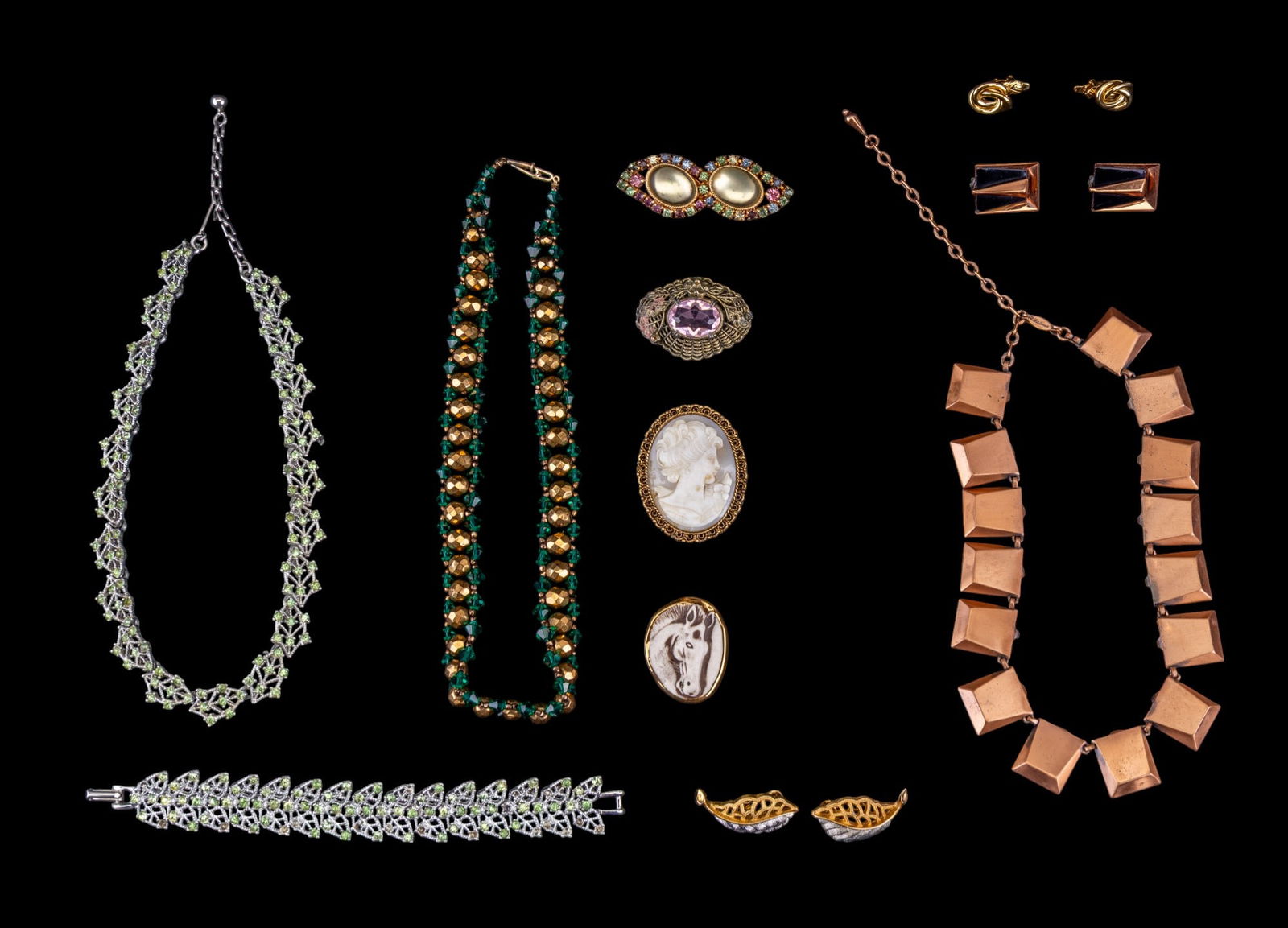 Vintage Estate Jewelry: An assortment of vintage jewelry including three necklaces featuring Matisse copper tone necklace with matching clip on earrings, Peridot rhinestone silver tone necklace and bracelet, green and gold t