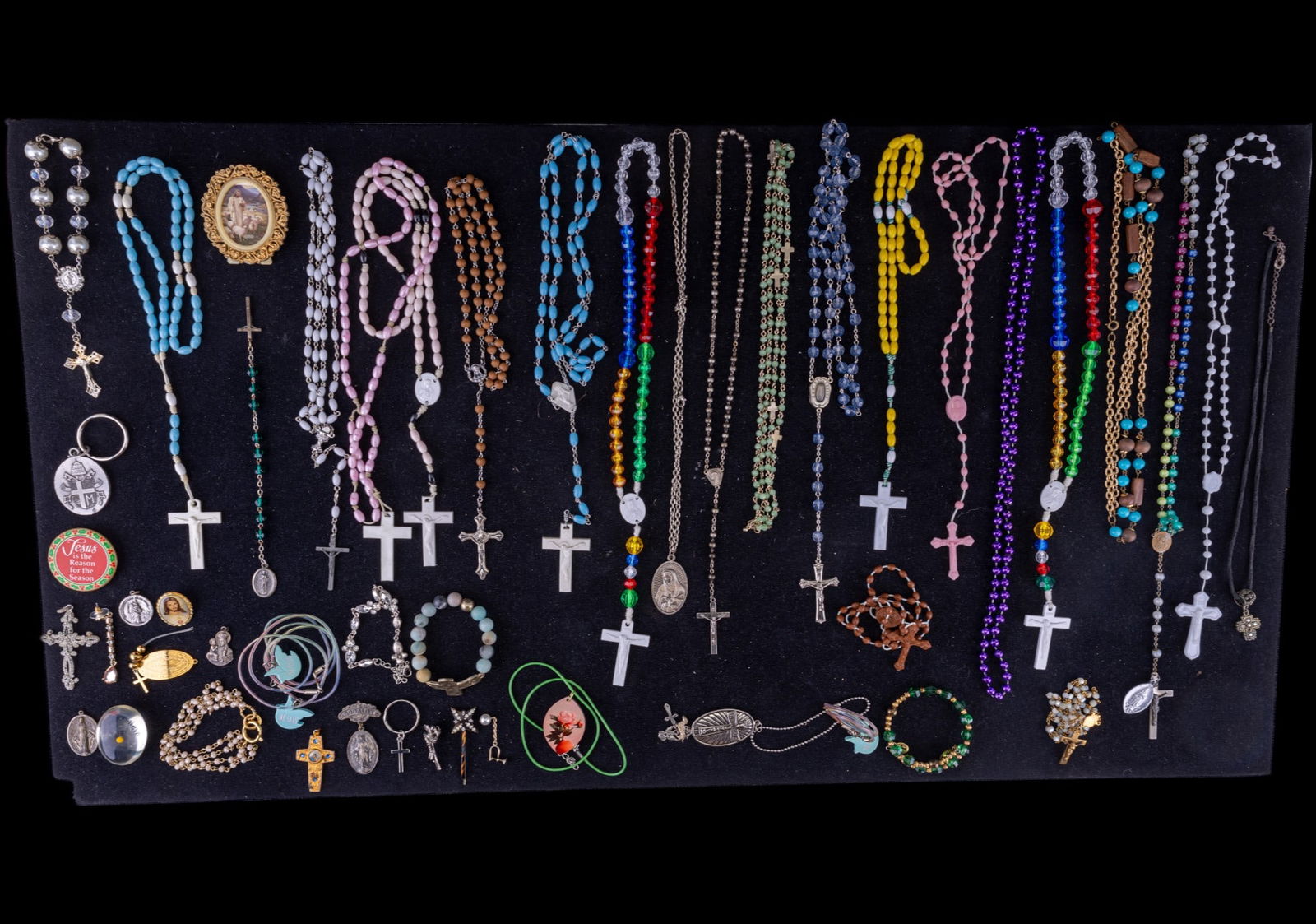 Rosaries and Related Jewelry: Lot includes myriad religious themed jewelry including pins, necklaces, various rosaries and more.