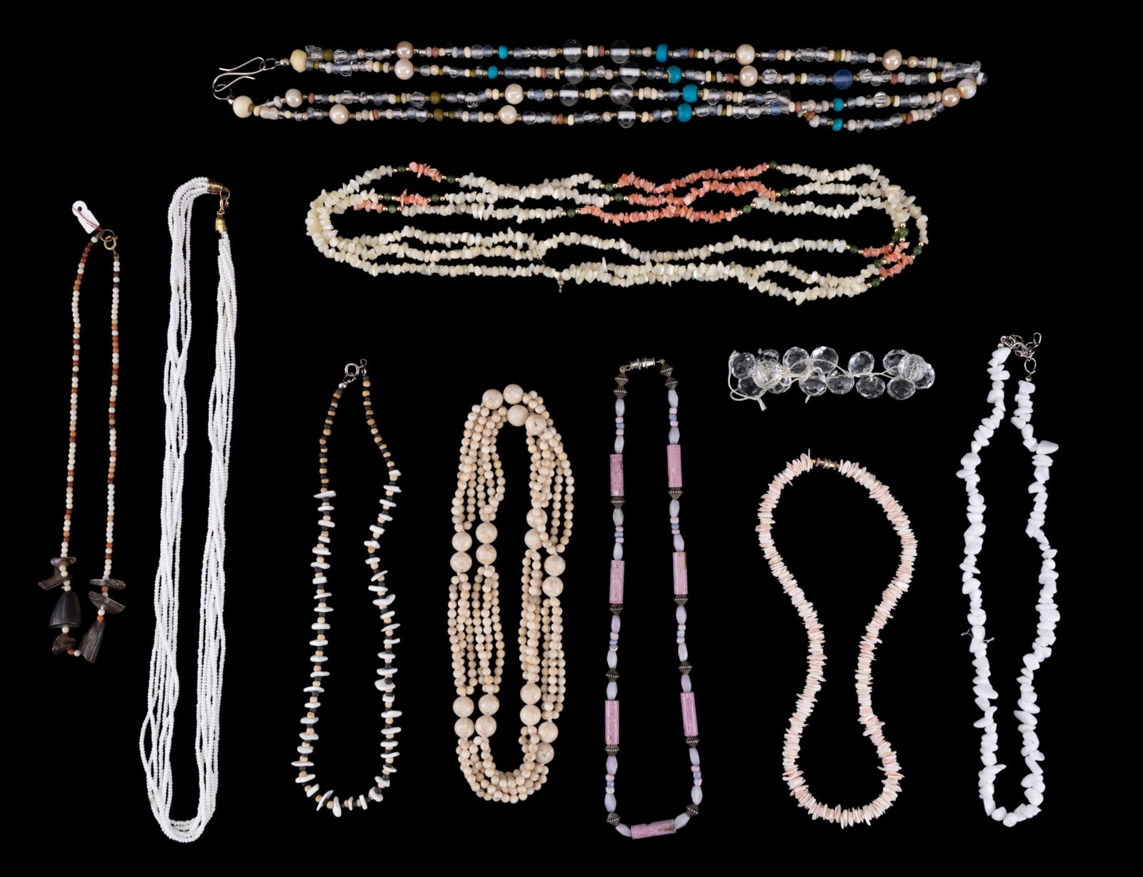 Shell, Stone, & Glass Bead Jewelry (10 Pcs.): Collection of 9 necklaces & 1 bracelet including a light pink puka shell necklace approx. 16" long, other shell necklaces, some stone bead necklaces, a necklace w/ glass beads & other bead types, & a