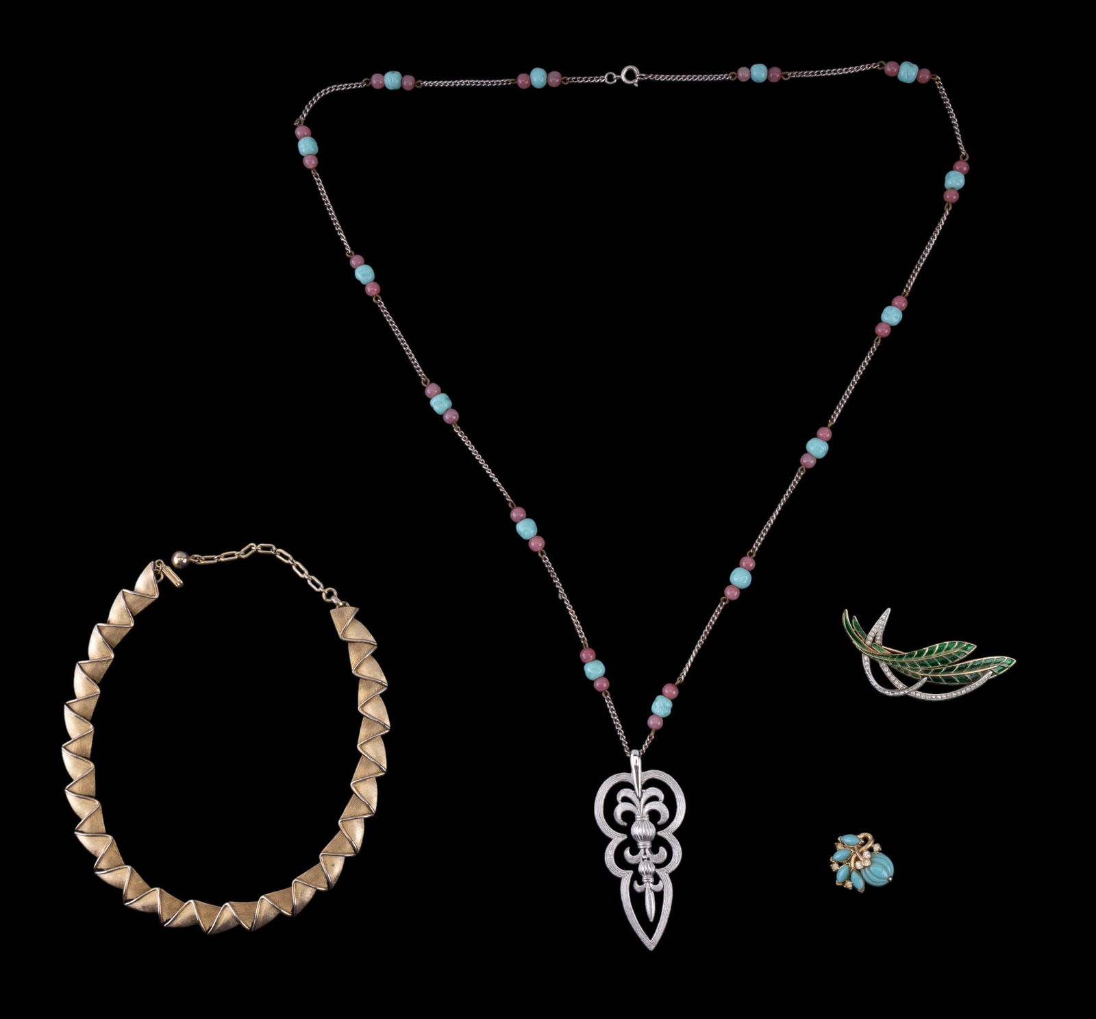 Trifari Designer Necklaces (2), Brooch, & Earring: Trifari silver tone necklace w/ stylized fleur-de-lis pendant & pink & turquoise-colored glass beads, Trifari gold tone ribbon choker necklace, Trifari gold tone & silver tone leaf brooch w/ green ena