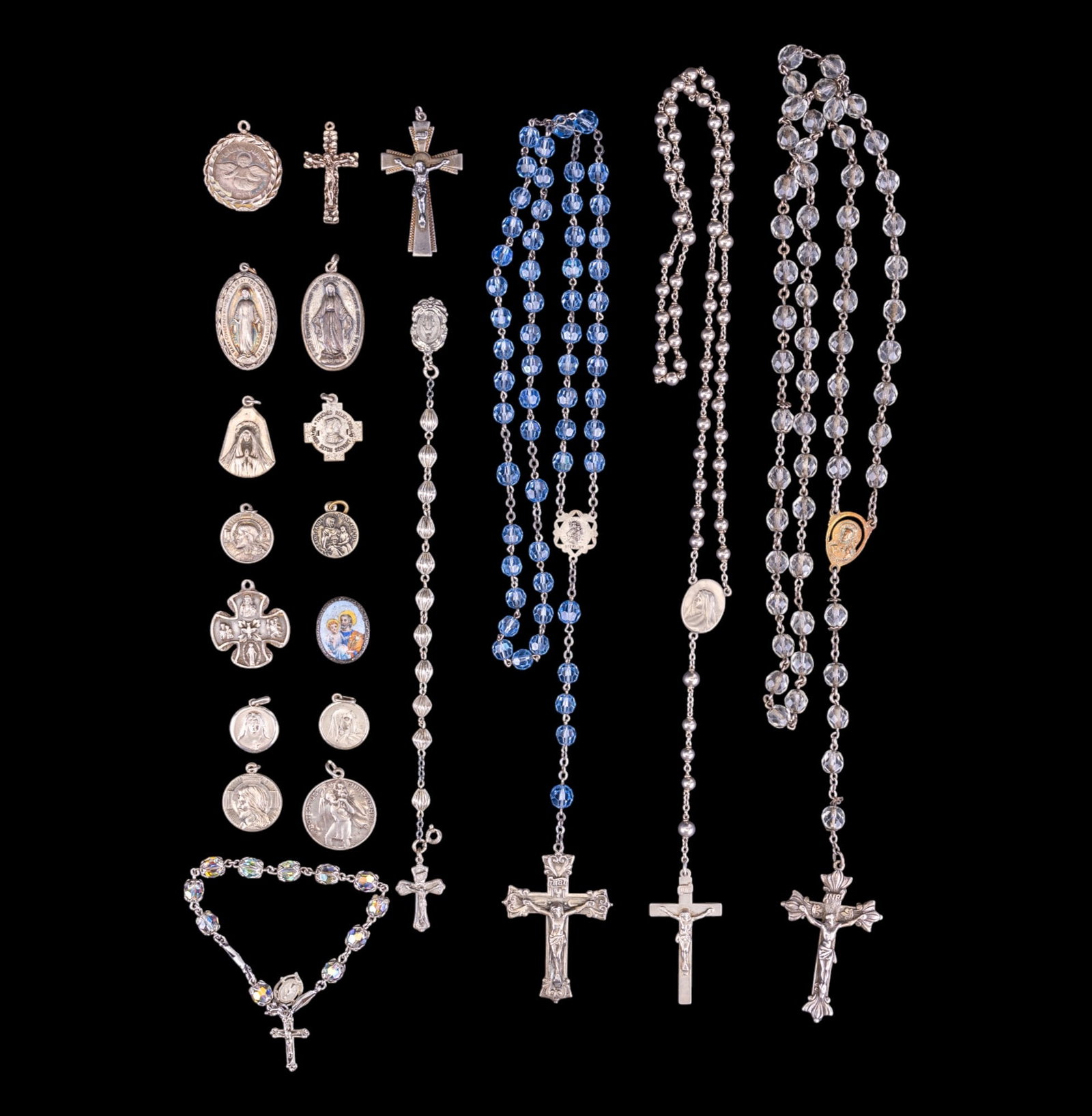 Sterling Catholic Rosaries & Prayer Medallions: Collection of sterling silver Catholic items including 3 rosaries (1 also has sterling beads & weighs approx. 22 grams), 2 finger rosaries / one-decade rosaries, 2 crucifix pendants, 12 prayer medalli