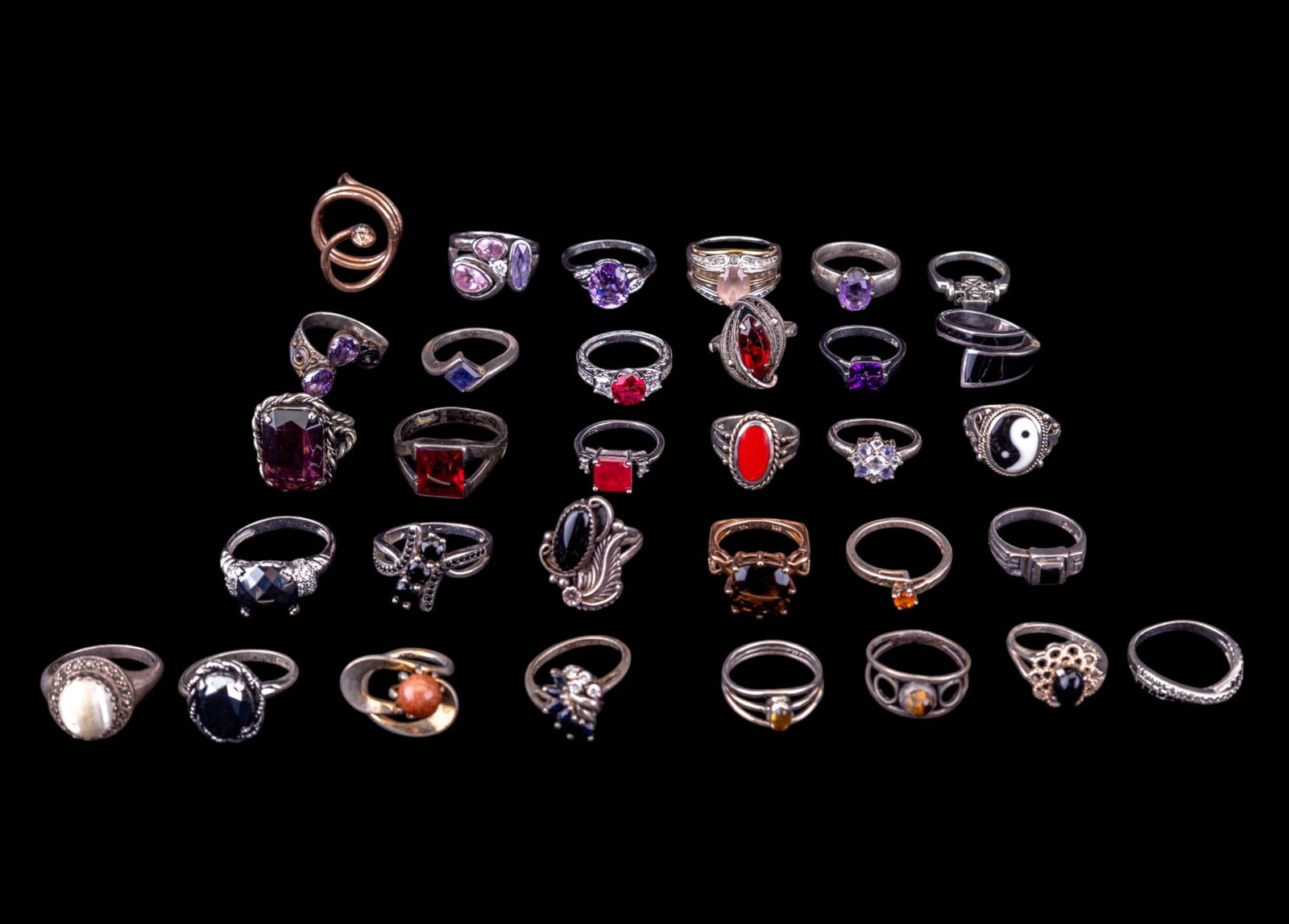 Sterling Silver and Stone Rings (32): A collection of 32 sterling silver rings featuring a vintage copper tone articulating coiled snake that can be uncoiled, onyx cabochon, cut amethyst, rhinestones, and more. Sizes range from 5 to 12.