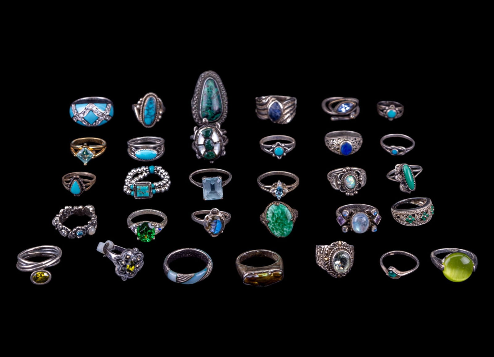 Sterling Silver and Stone Rings (31): A collection of 31 sterling silver rings featuring Columbian Emerald, lapis lazuli, peridot, moonstone, opal, turquoise, and more. Sizes range 3.5 to 11.