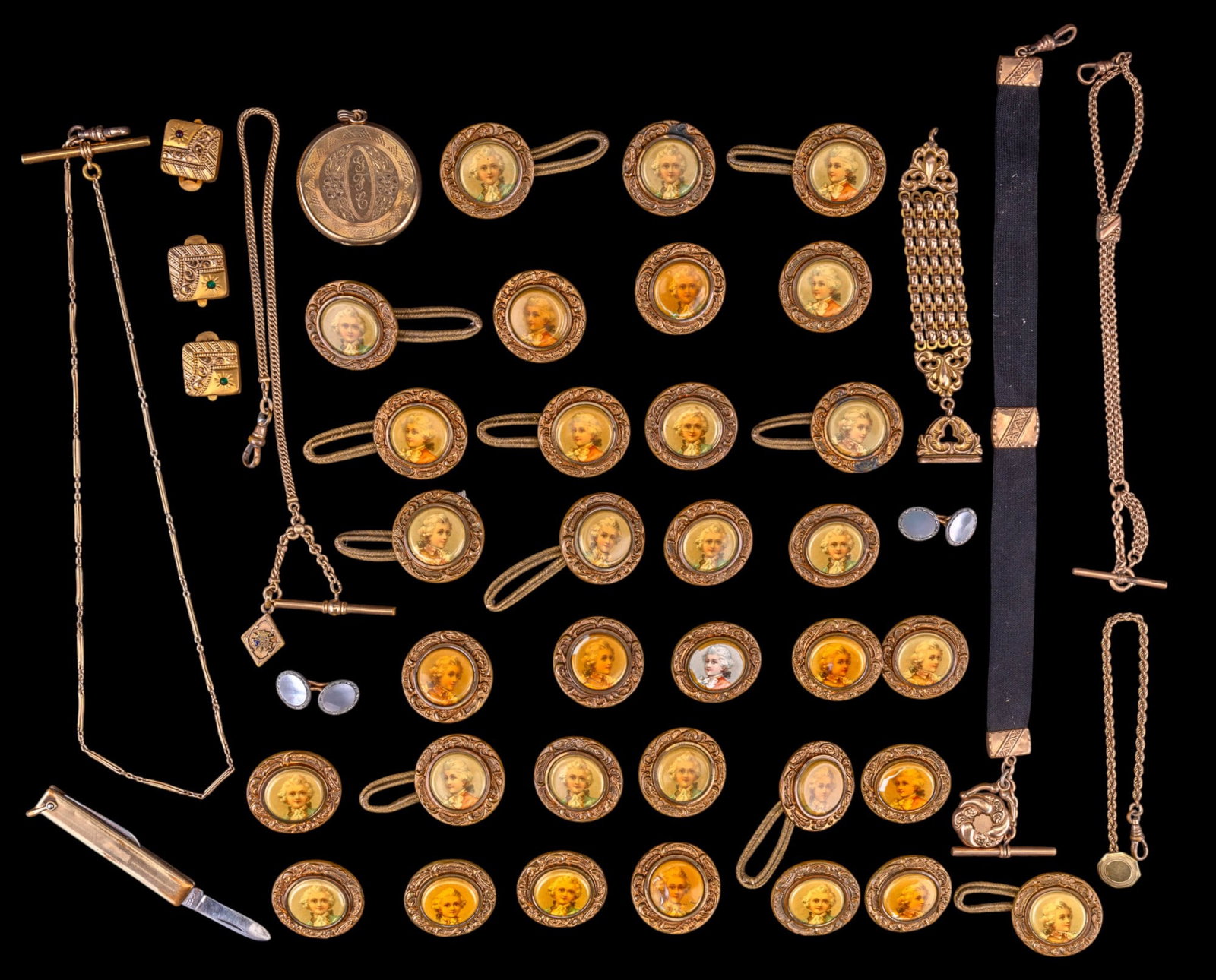 Victorian Watch Accessories and Buttons: A collection of Victorian gold tone watch fobs, fob chains, large locket, clip on buttons with incised details and rhinestones, a 12K GF pocket knife, and an assortment of 33 Art Nouveau celluloid but