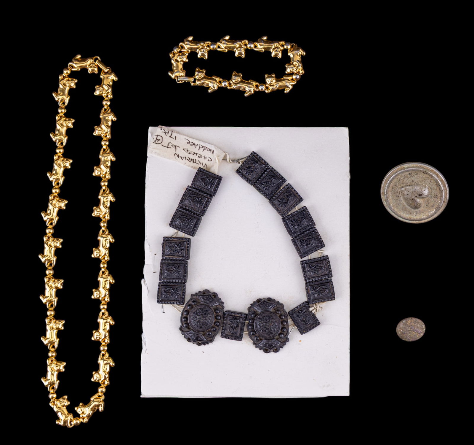 Victorian Carved Bog Jewelry, Buckle, Avon: Victorian carved jet black bog choker (mourning jewelry / bog oak carved links) does not have a clasp and is strung but attached to cardboard. Lot also includes an Avon gold tone figural cat link neck