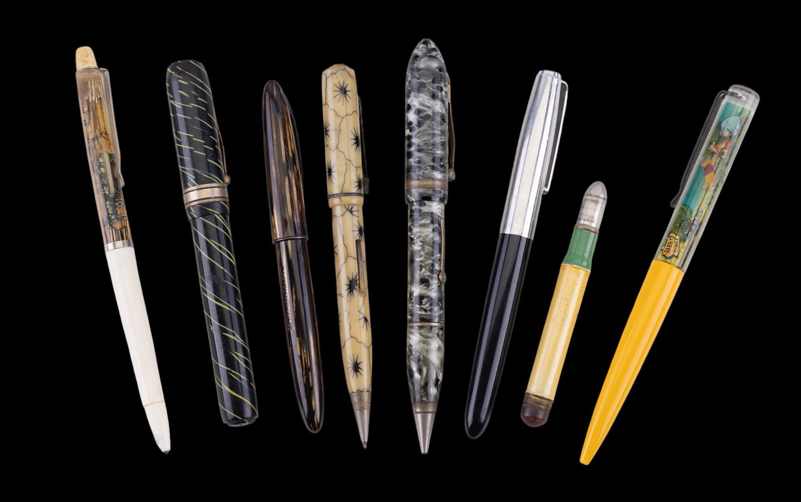 Sheaffer, Remington, and Other Pens: A collection of fountain and ball point pens featuring a ti'ger's eye inlay fountain pen with 14K gold nib by Sheaffer, celluloid pen marked with an 'S', celluloid Remington pen and pencil combo, an u