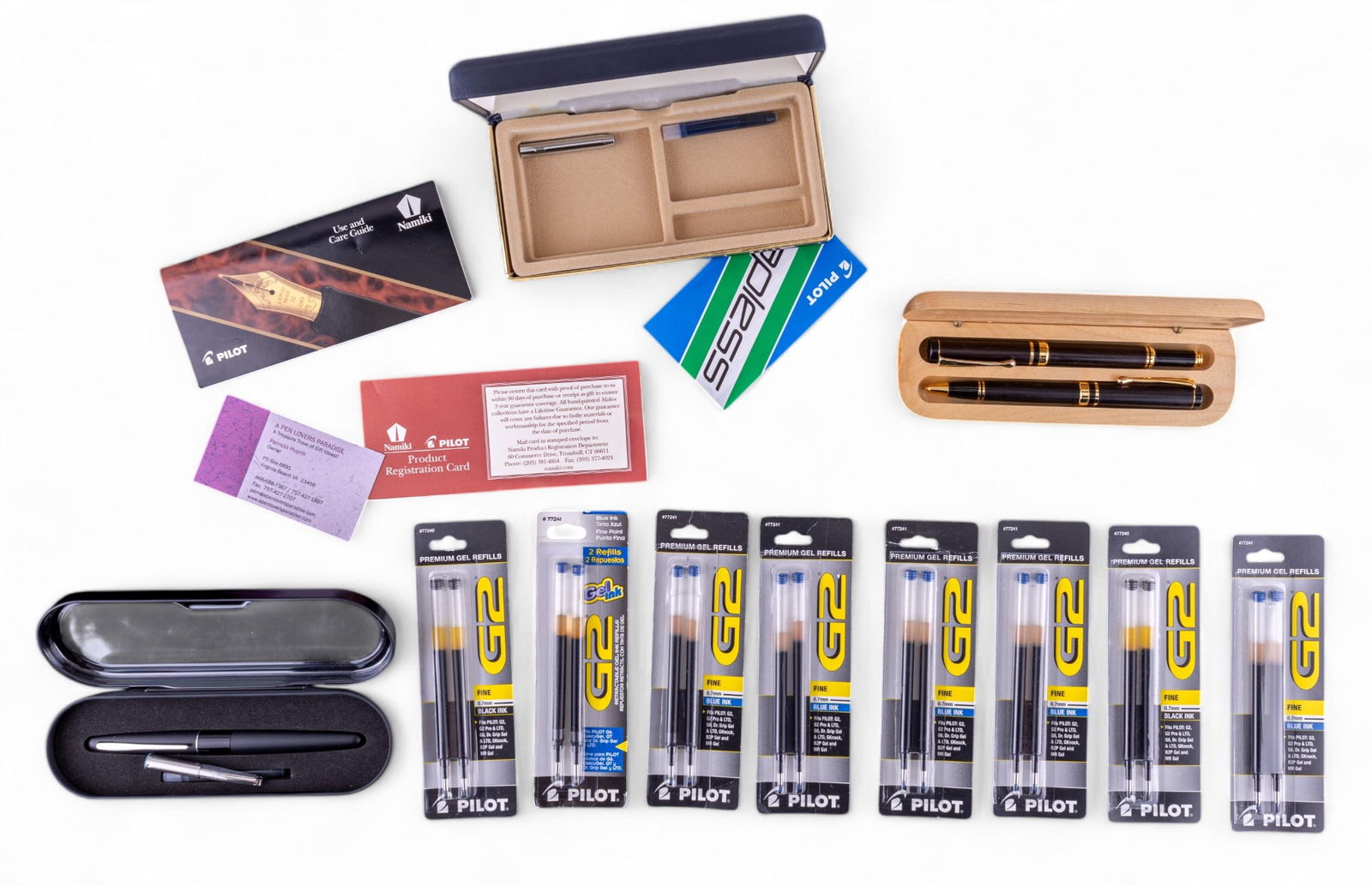 Pilot and Other Fountain Pens: Pilot Metropolitan fountain pen in original case and box #91107, an empty Pilot Namiki pen case, an unmarked set of wood and plastic fountain pen and graphite mechanical pencil in a wooden case, and 8