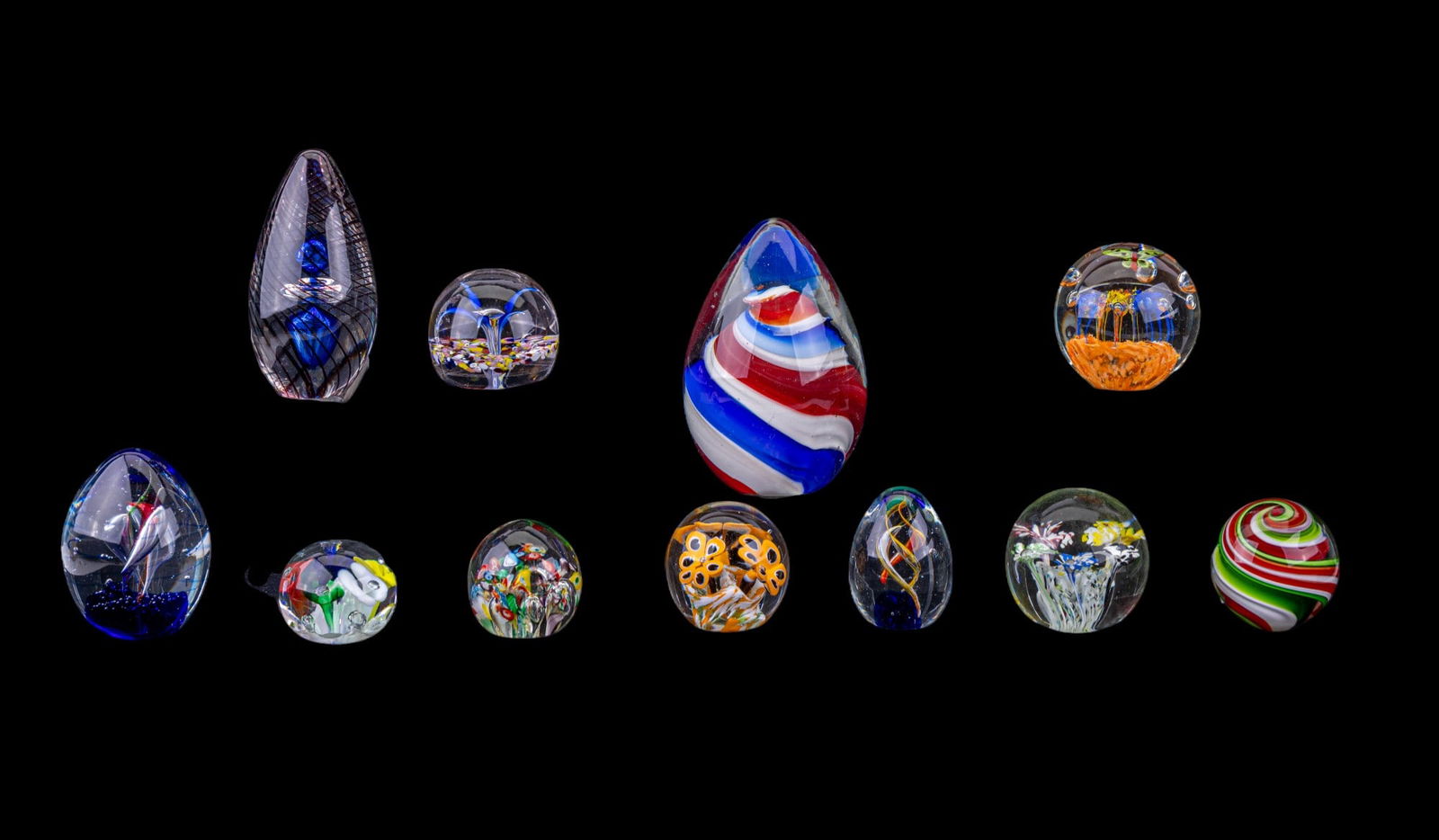 Blown Glass Paperweights (11): A collection of blown glass art paperweights featuring designs by Joe St. Clair and Dynasty Gallery Heirloom Collectibles, sizes range between 2.25" and 7" H.