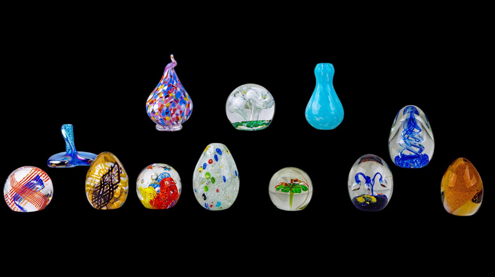 Blown Glass Paperweights and Glass Art: A collection of 9 blown glass art paperweights, three of which are signed featuring 'Stars N' Stripes' #226665, 'Tartan Weave' #C8286, and a design with etched butterflies #C12856, by glass artist Cai