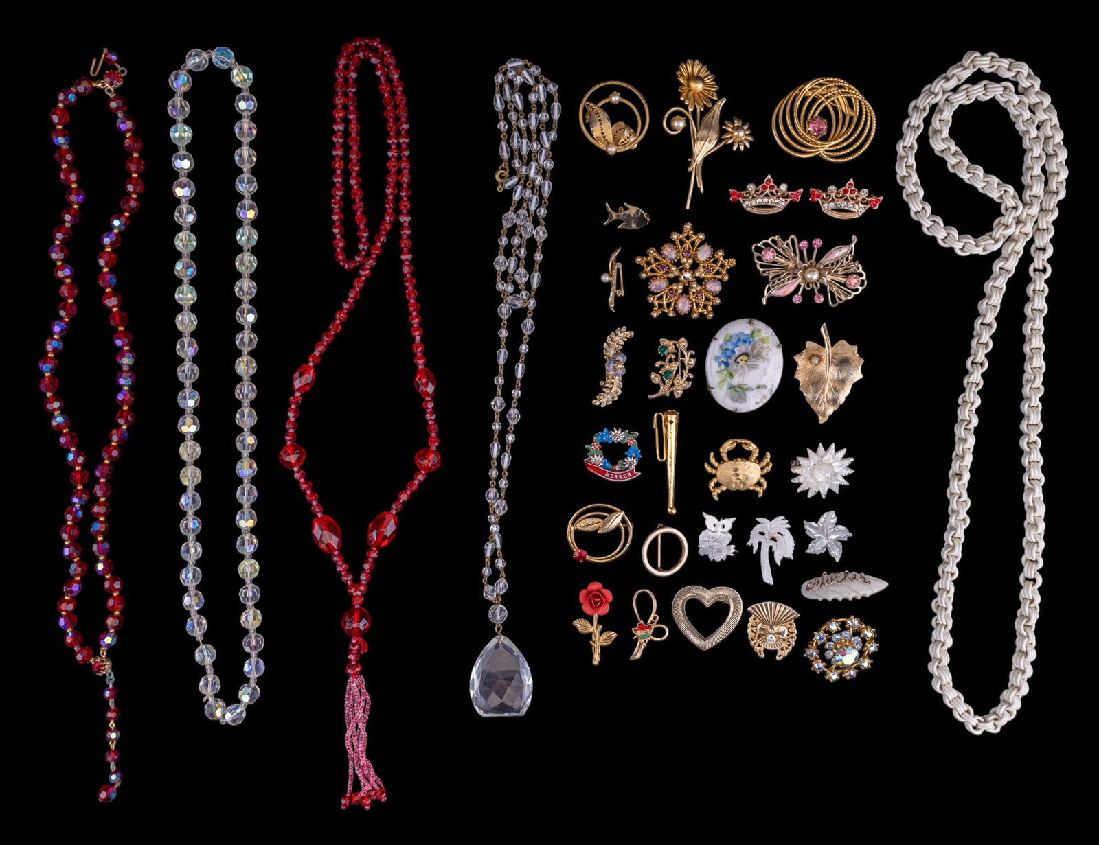 Art Deco and Vintage Estate Jewelry: Art Deco red glass tassel and clear drop necklaces, other various necklaces, and an assortment of gold tone, rhinestone, floral enamel, and mother of pearl brooches.
