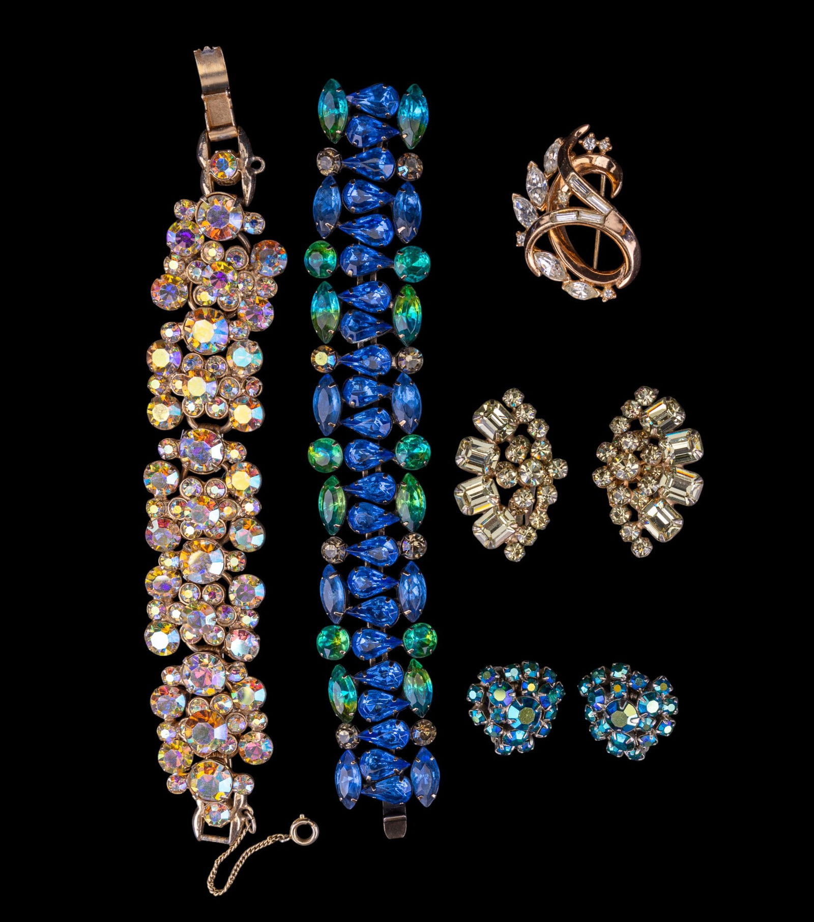 Kramer, Trifari, and Estate Jewelry: Blue and green rhinestone crystal bracelet by Kramer of New York, gold tone Trifari brooch, and other large unsigned rhinestone jewelry.