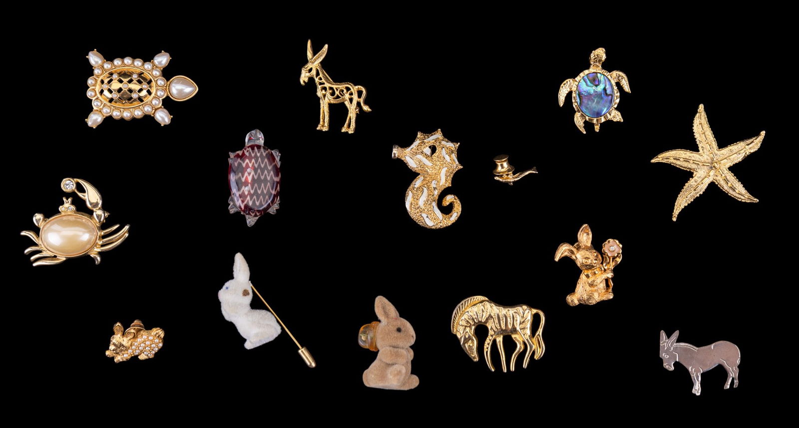 Figural Animal Brooches + Pins, Nautical, Rabbit: Grouping of figural pins + brooches including a faux pearl crab brooch, multiple fashion turtle brooches (one with Abalone accent), a turtle lucite brooch, gold tone starfish brooch, faux pearl gold t