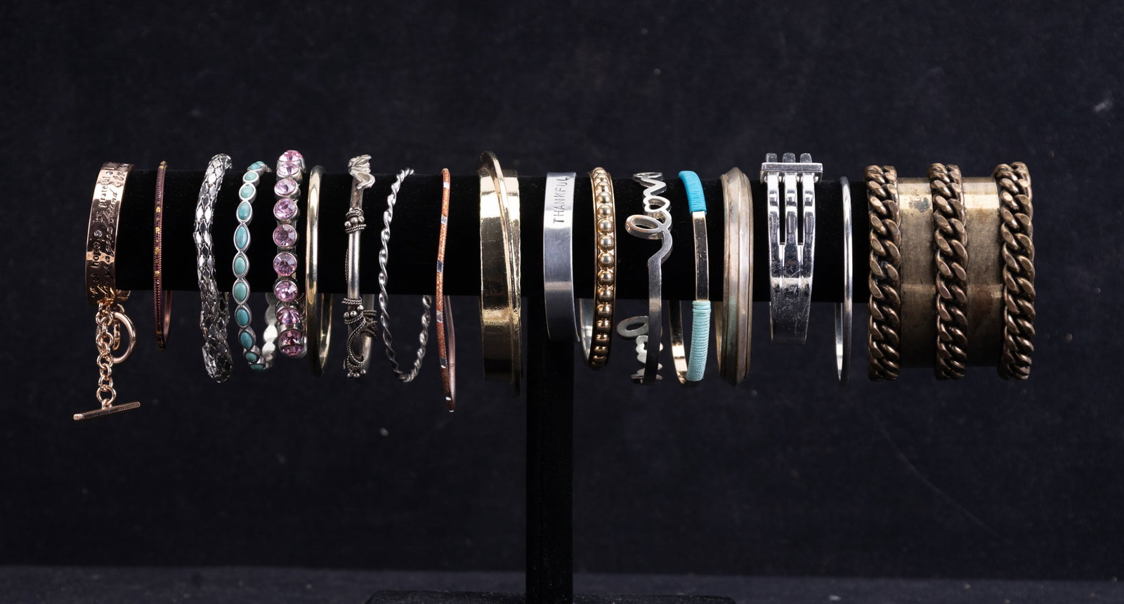 ~70 Assorted Bangle Bracelets: A collection of approximately 70 bangle bracelets, including a variety of designs. The selection features a faux pearl bangle, L+D bangles, a Belle Ryan bangle, rhinestone bangles, and additional piec