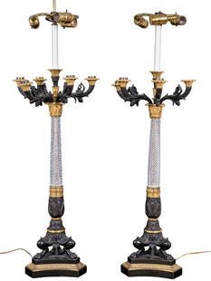 Fine Baccarat Crystal Bronze Footed Candelabras: A pair of fine Baccarat crystal and bronze footed candelabras on black marble base measuring approximately 37" high. Gilt bronze and black patina, five armed candelabra with hand cut crystal fitting o
