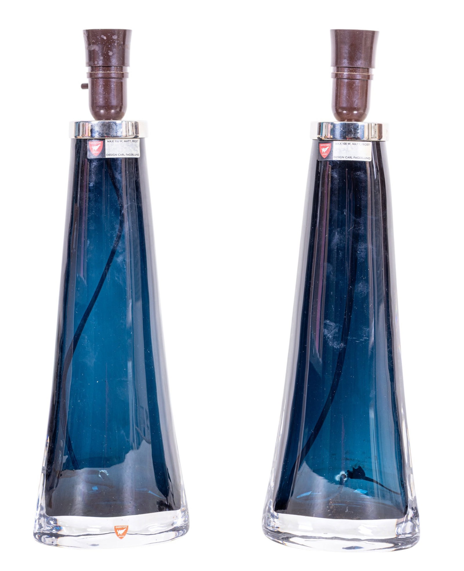 Orrefors Art Crystal Blue Lamps by Carl Fagerlund: A pair of dark blue colored crystal Orrefors lamps designed by Carl Fagerlund each measuring approx. 17" high each in great condition. Weight: 7.4 pounds each, 15 pounds total.