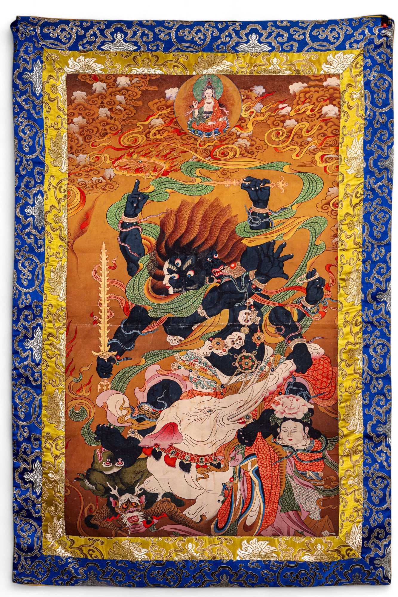 Tibetan Tourist Tapestry: Tourist souvenir Tibetan tapestry featuring a contemporary heat transferred design and embroidered silk border, note wear to image, measures approx. 28" W x 42" H.