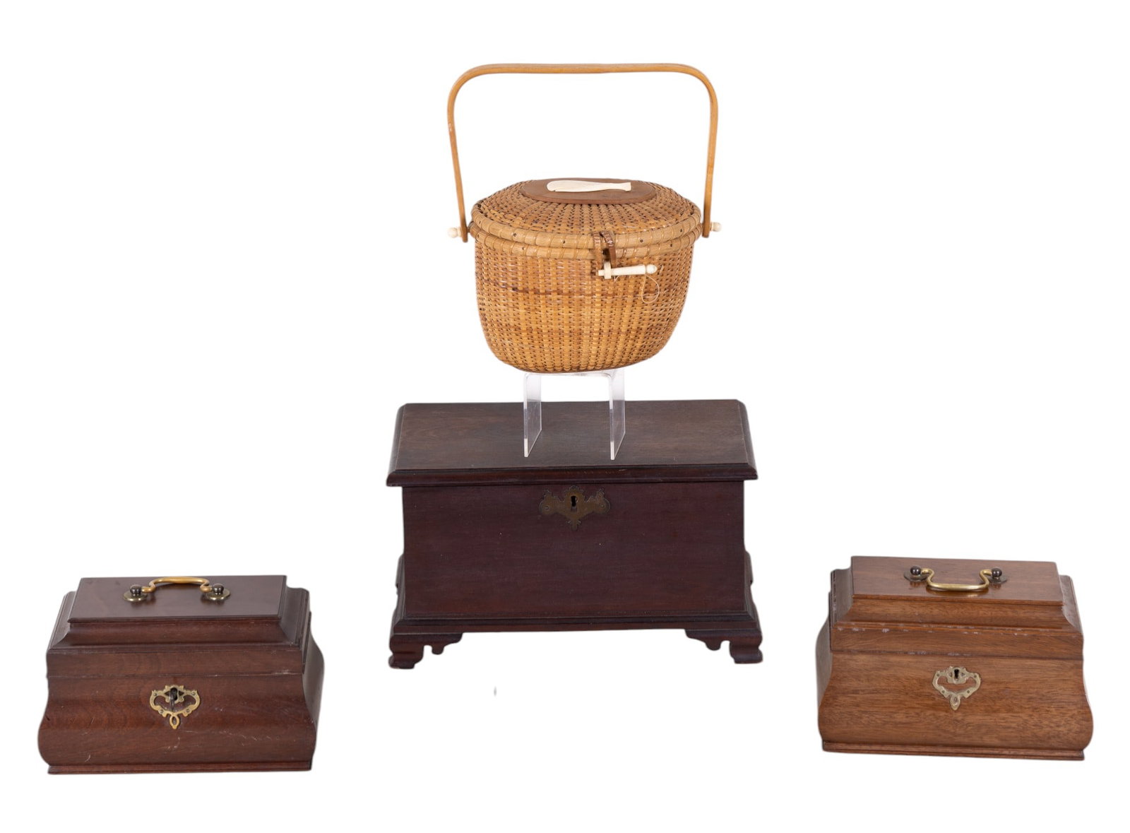 Mini Wood Chest, Jewelry Boxes, Nantucket Basket: Early wood miniature blanket chest with key, 13.5" W x 7.5" D x 8" H, note loose back foot will require repair, two Colonial Williamsburg Restoration Virginia Metal Crafters jewelry boxes, darker one 