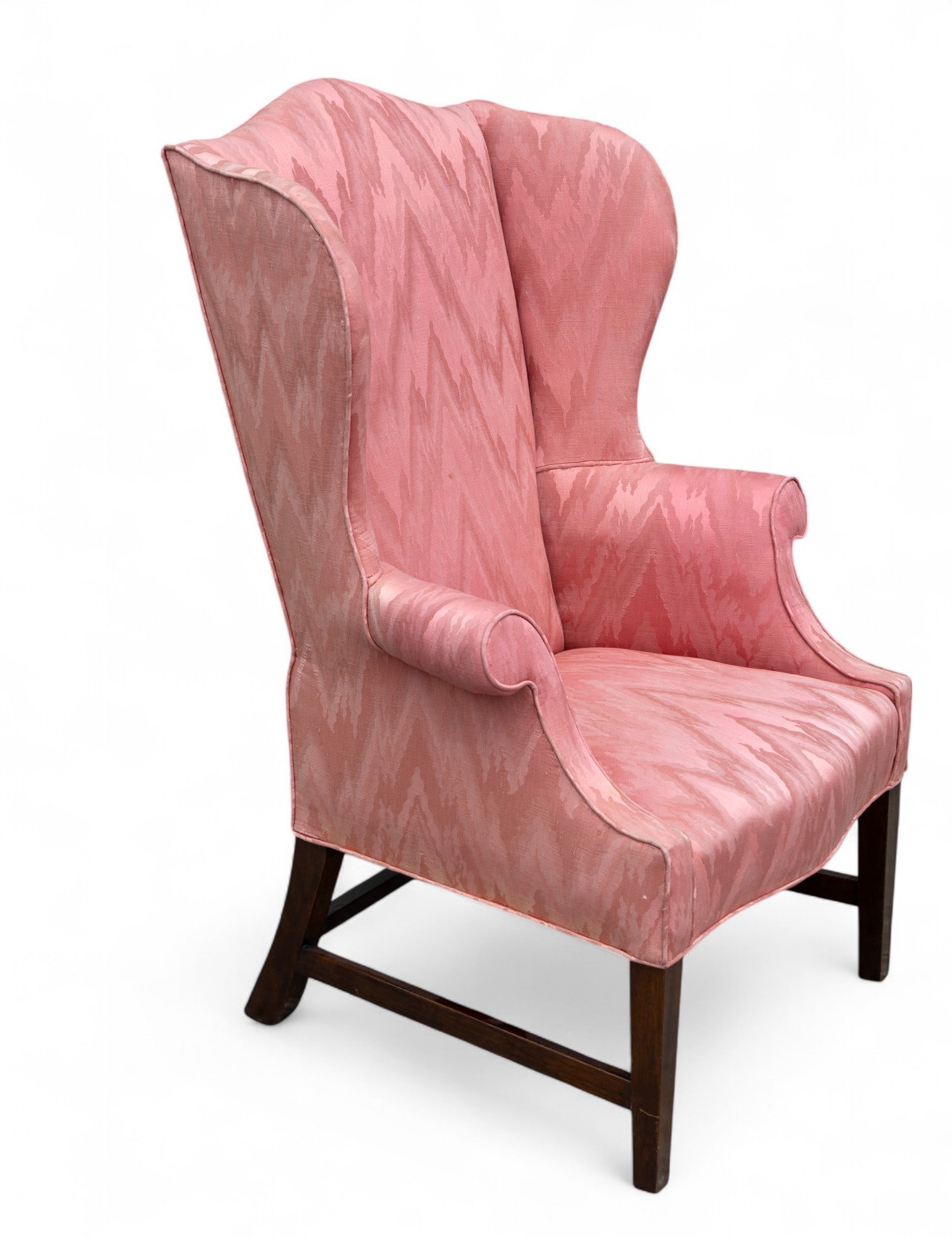 Hepplewhite Style Wingback Armchair: Wingback armchair with pink zigzag-patterned upholstery. Features high back and rounded armrests with tightly upholstered finishing. Stands on four wooden legs, slightly tapered in front and straight 