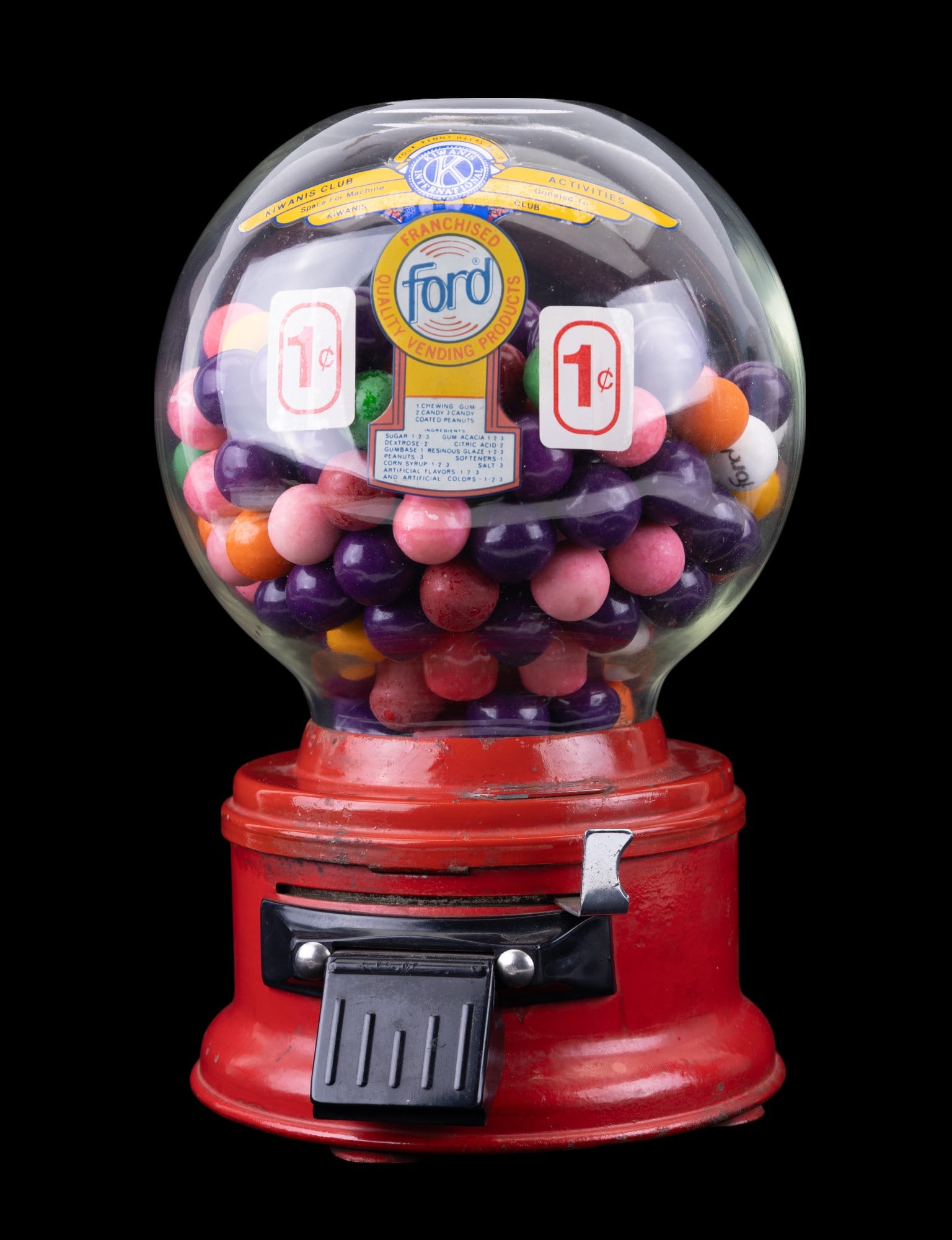Ford Countertop 1 Cent Gumball Machine: A Ford countertop one cent gumball machine, with Kiwanis International advertisement on front. Gumballs for display purposes only, do not fit from chute. Gumball machine in functioning condition. Key 