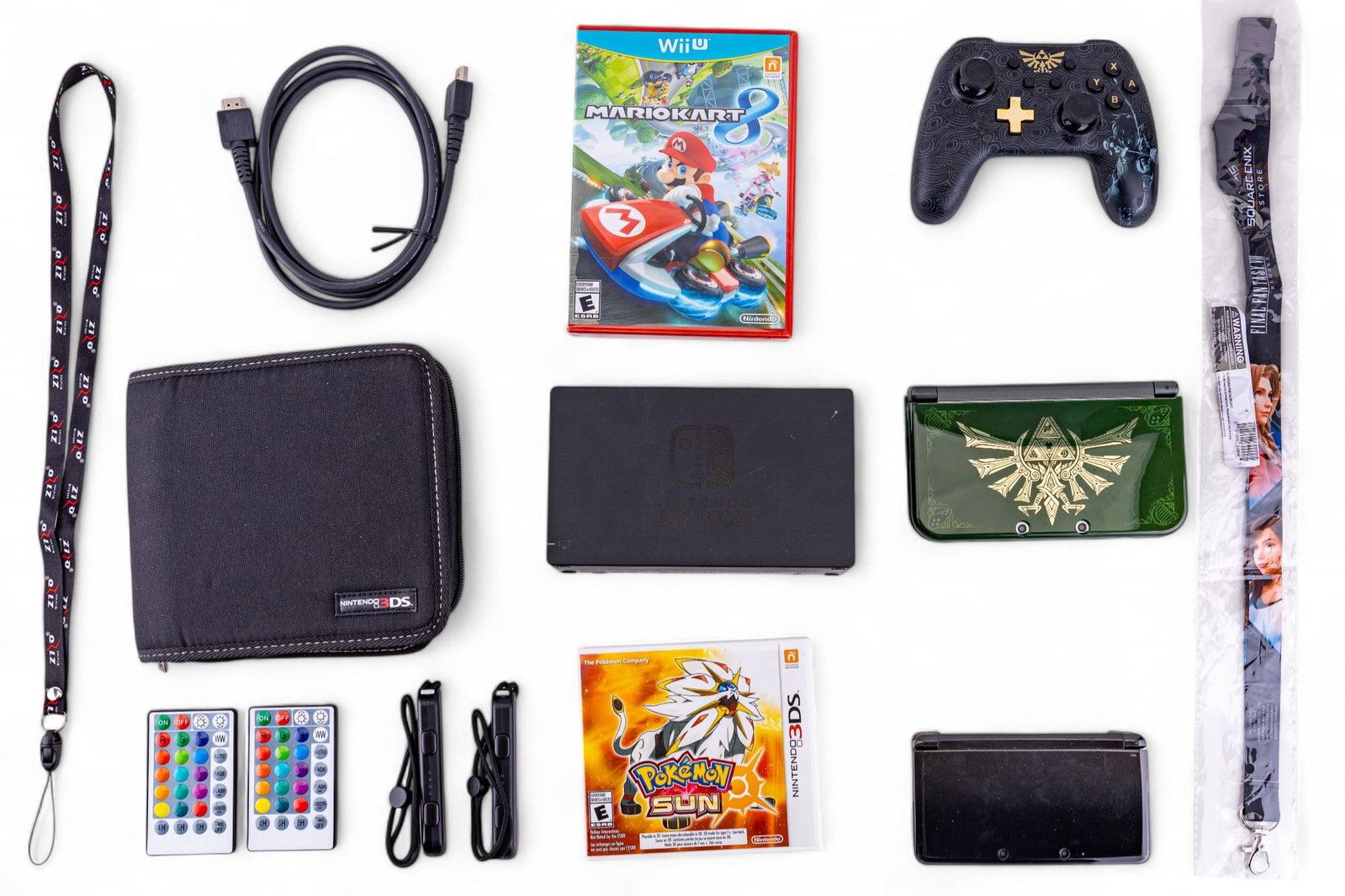 3DS, Switch controller, Port, Pokemon DS, more: Grouping includes a 3DSXL in good condition with Zelda case, a 3Ds in good condition with Pokemon X inserted, a NIB Mario Kart 8 game for Wii U, a Pokemon Sun 3DS game with original box, a switch char