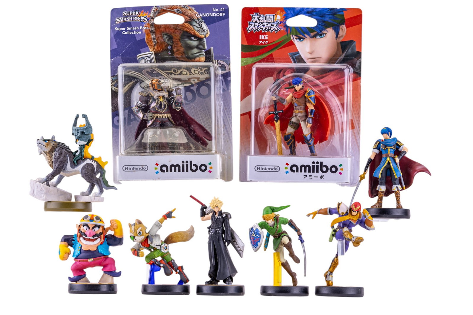 Nintendo Amiibo Large Grouping (9 Pc.): Grouping of Nintendo Amiibos, two of which are new in box. A NIB Ganondorf, NIB Ike, Cloud, Falcon, Fox, Wario, Link, and Marth. Video games.
