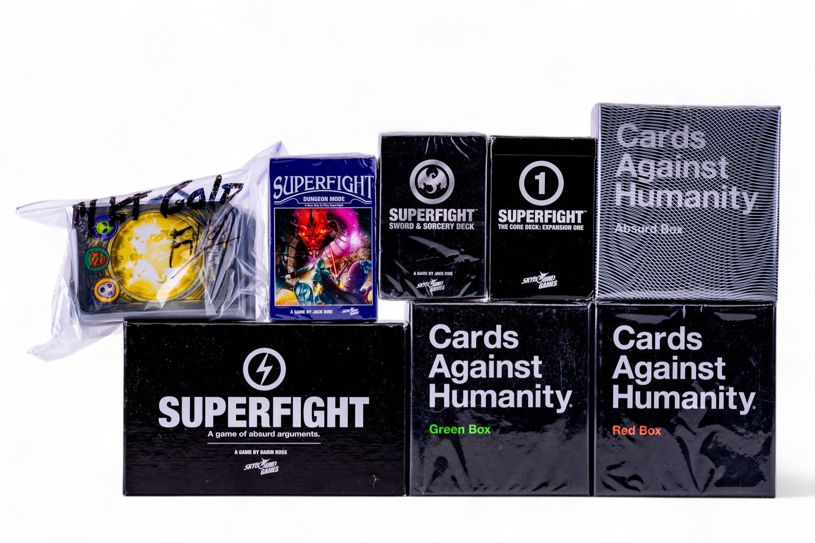 Cards Against Humanity Expansions and Superfight: A collection of SkyBound Games Superfight card game with three expansion packs, including the Sword and Sorcery pack and the Dungeon Mode pack, Card Against Humanity expansion packs including Green, R