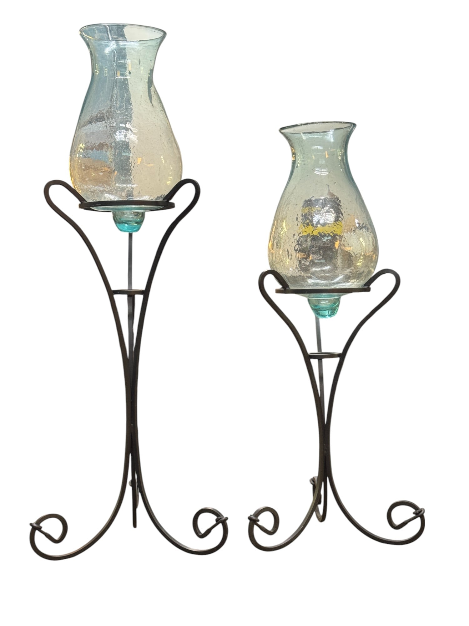 Hand Blown Jardinieres on Wrought Iron Stands: A pairing of two jardinieres on wrought iron stands measuring approx. 55" and 44" high respectively. One jardiniere is cracked with no loss to glass as seen in photography.