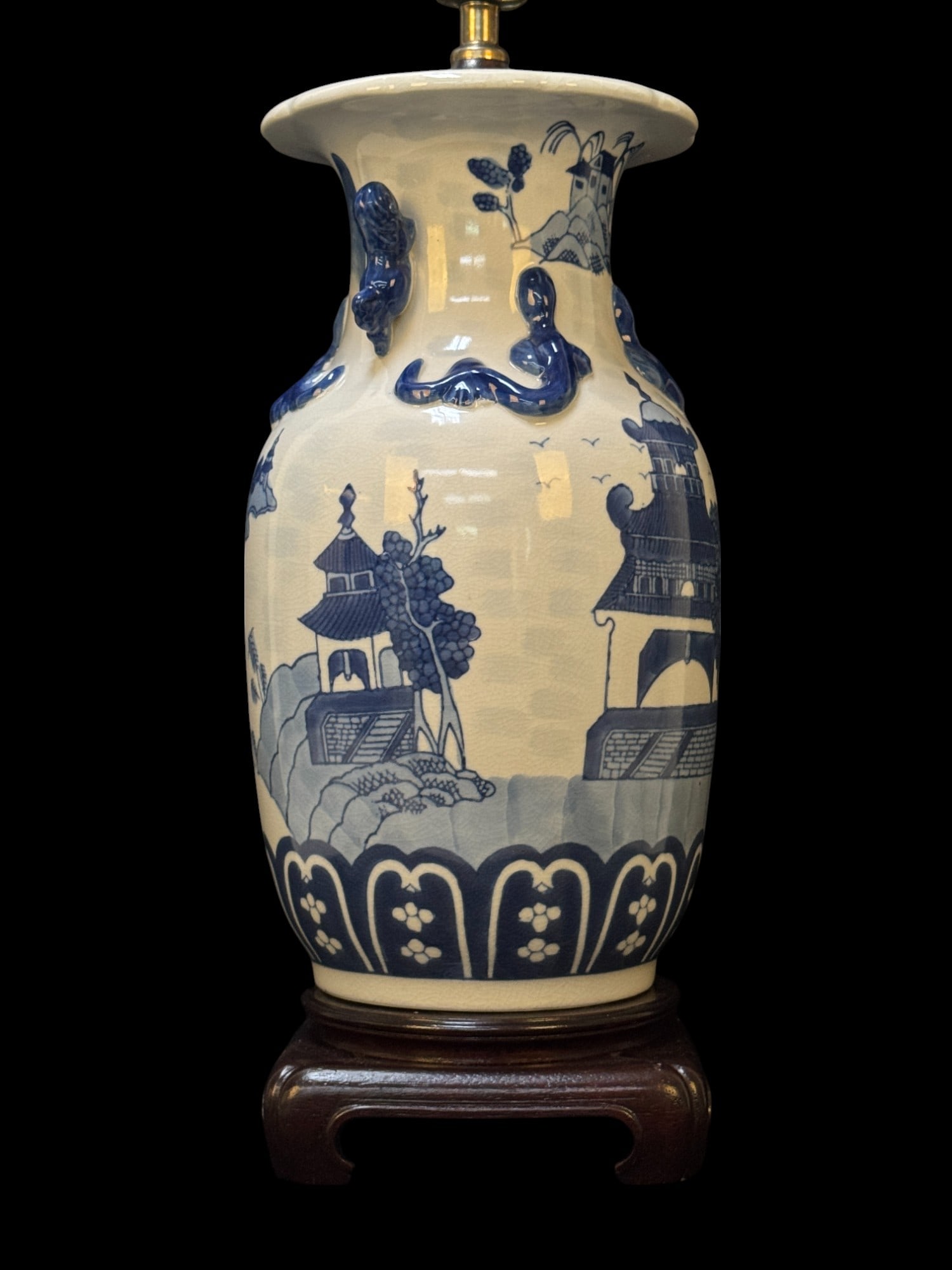 Antique Chinese Blue & White Lizard Vase: An antique Chinese blue & white vase fitted for lamp with handpainted scenes and lizard raised ornaments along with foo dog handles. Vase lamp measures approx. 31" high with harp on wooden base.