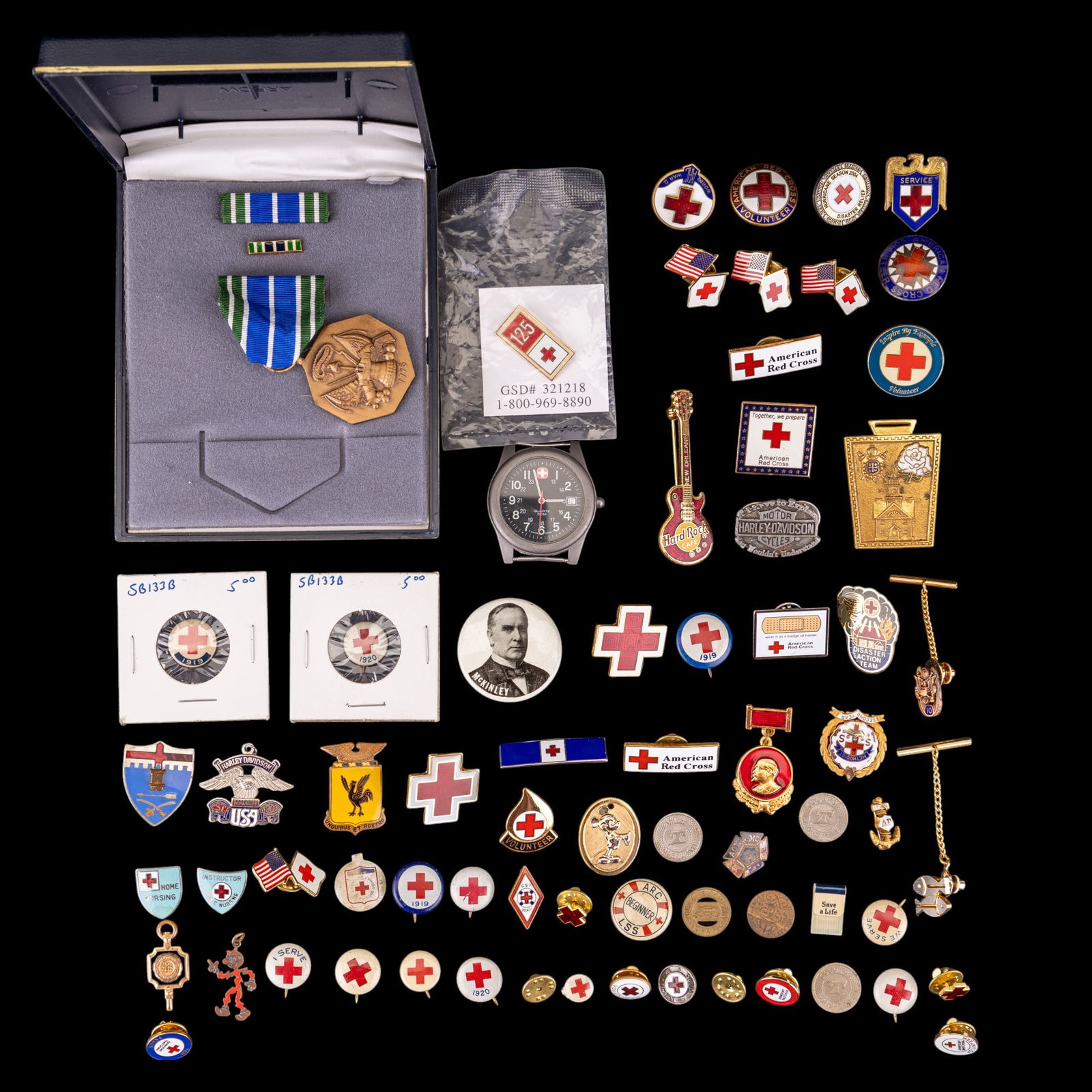 Antique American Red Cross Pin Backs: A collection of antique and contemporary American Red Cross pin backs and enamel lapel pins, Marlboro Wenger wristwatch movement, New Orleans Hard Rock Cafe pin, a vintage Vladimir Lenin pin, a gold t
