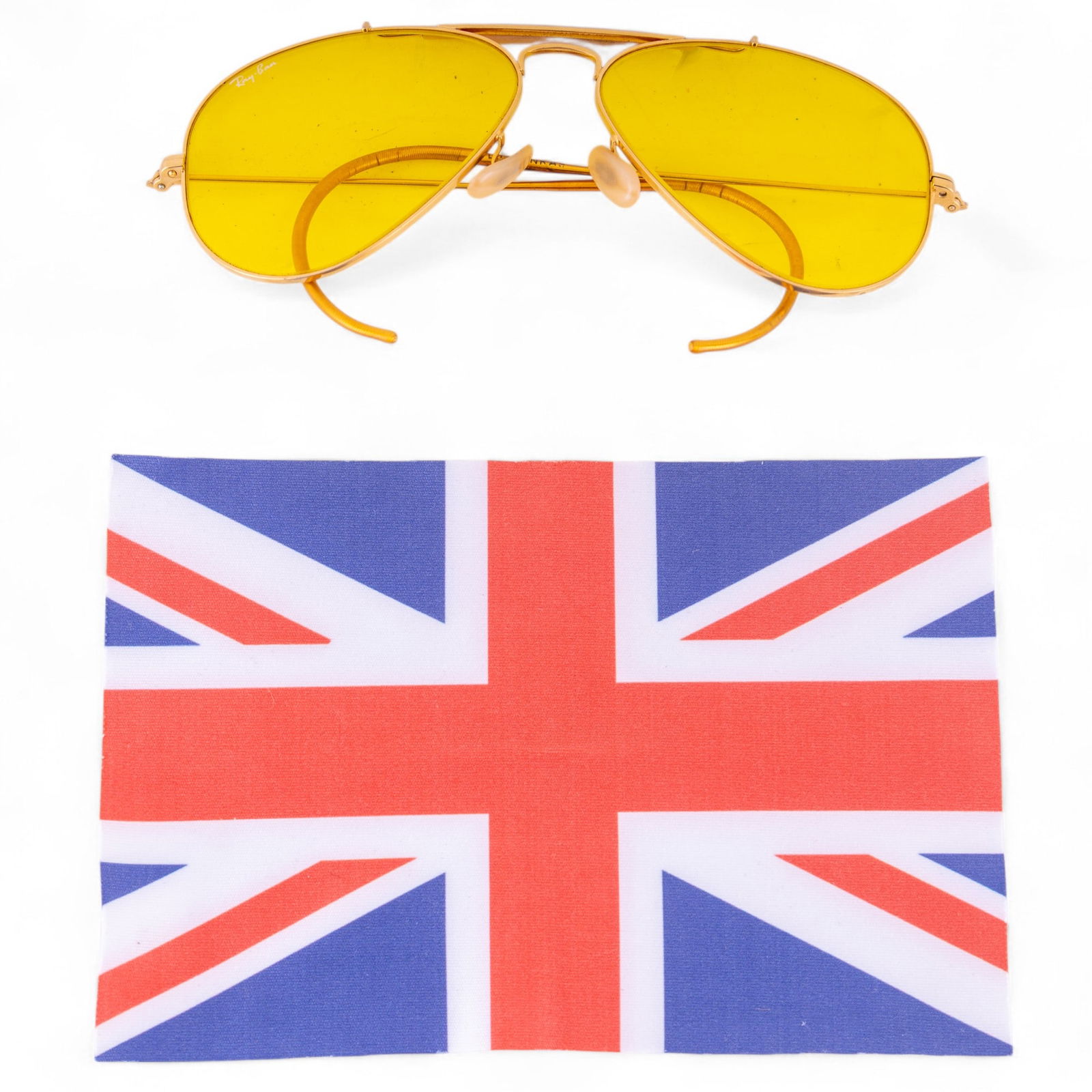 Mid Century RayBan 58-14 Yellow Aviator Sunglasses: Mid century RayBan 58-14 L0306 aviator sunglasses featuring a gold tone frames, rounded ear hooks, and yellow tinted lenses, also included is a Union Jack printed lens cloth from Jeff Banks London.