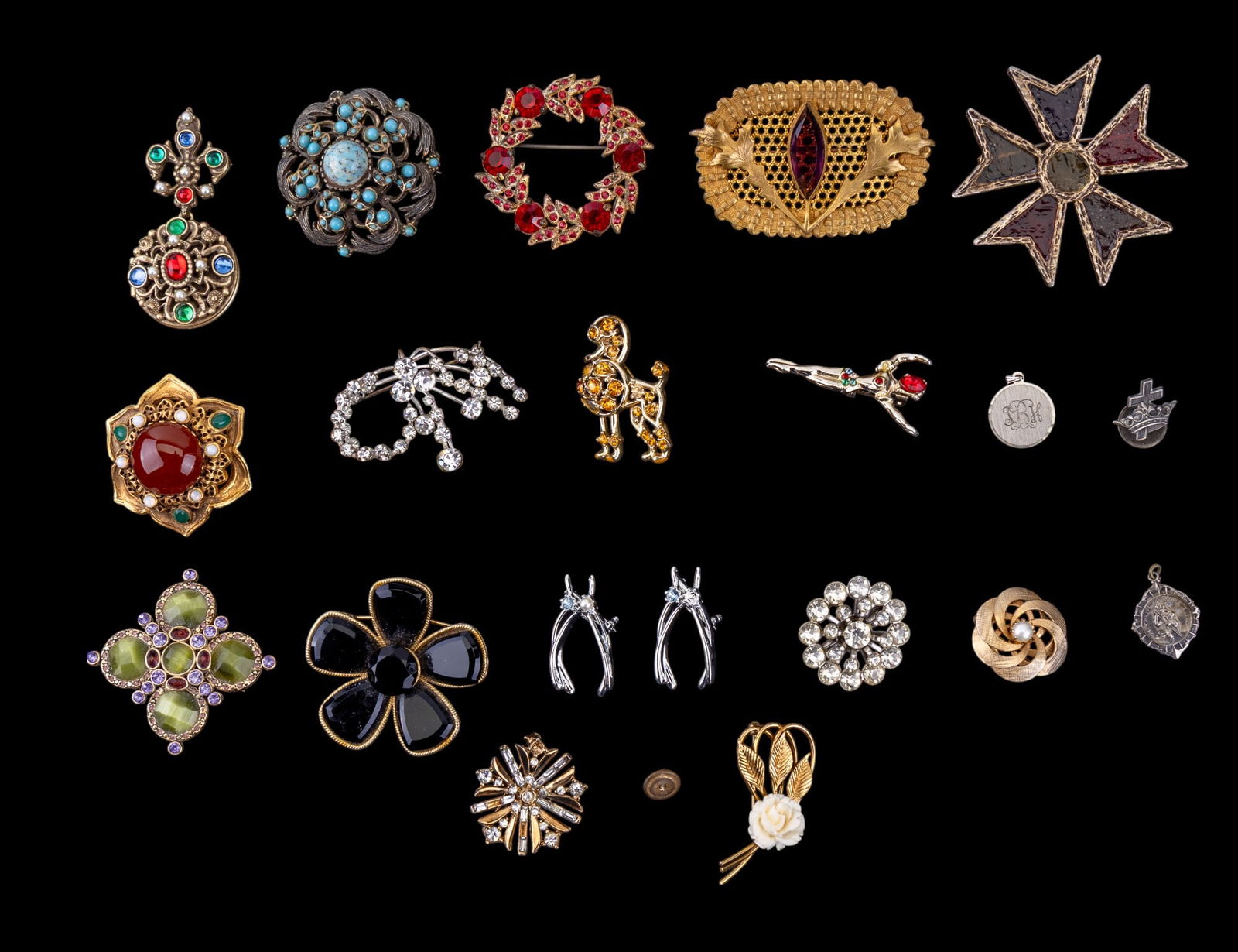 Vintage and Designer Brooches: A collection of vintage and designer brooches featuring a clear rhinestone starburst brooch/pendant by Crown Trifari, a black rhinestone flower brooch by Capri, a Monet rhinestone brooch, a vintage si