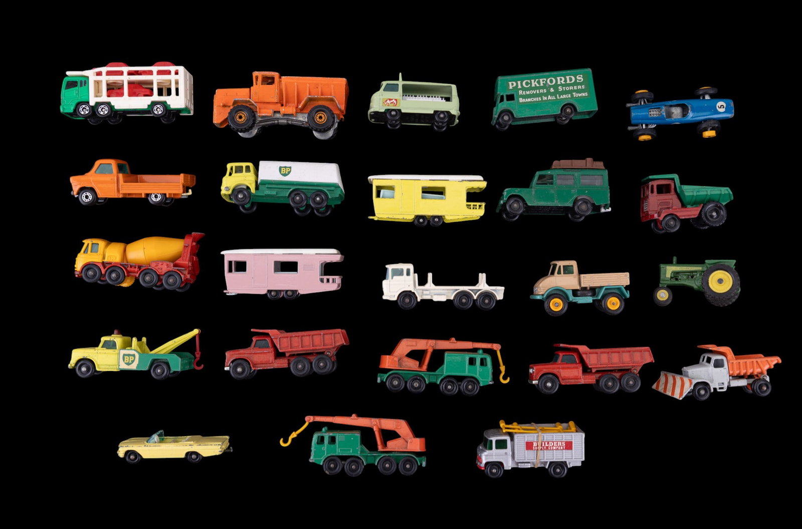 Vintage Lesney Matchbox and Other Toy Cars: A collection of vintage Lesney matchbox tankers, caravans and trucks, a Tomica Car carrier, and Hot Wheels construction vehicle.