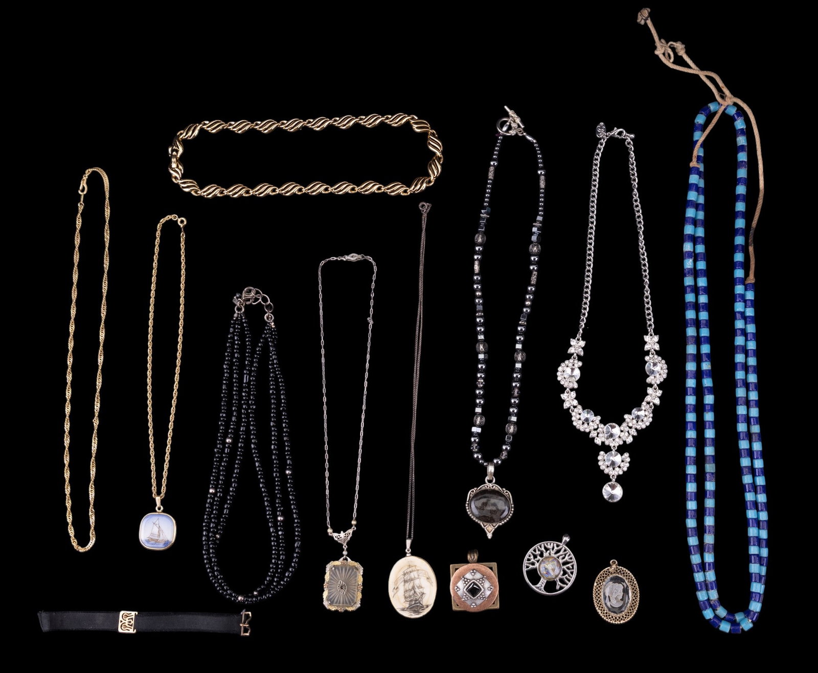 Gold Filled and Costume Necklaces and Pendants: A collection of costume necklaces and pendants featuring a scrimshaw pendant, a natural stone pendant with hematite strand, gold tone Napier necklace, onyx triple strand necklace with sterling clasp,