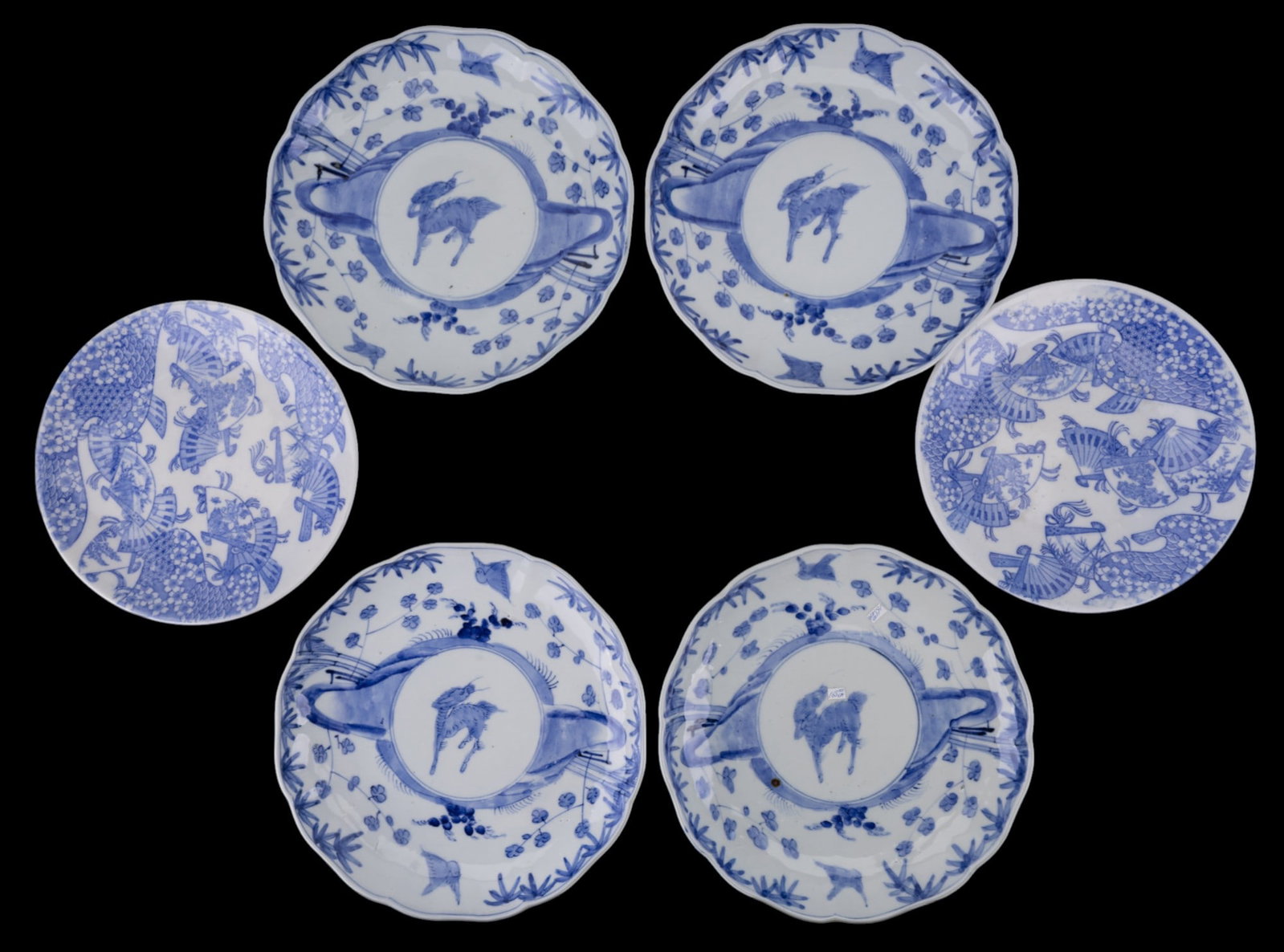 6 Old Japanese Blue & White Plates Meiji Era: An assortment of 6 Japanese blue & white porcelain plates, including 4 scalloped-edge plates with underglaze blue qilin and landscape motif, and 2 round plates featuring intricate fan and floral patte
